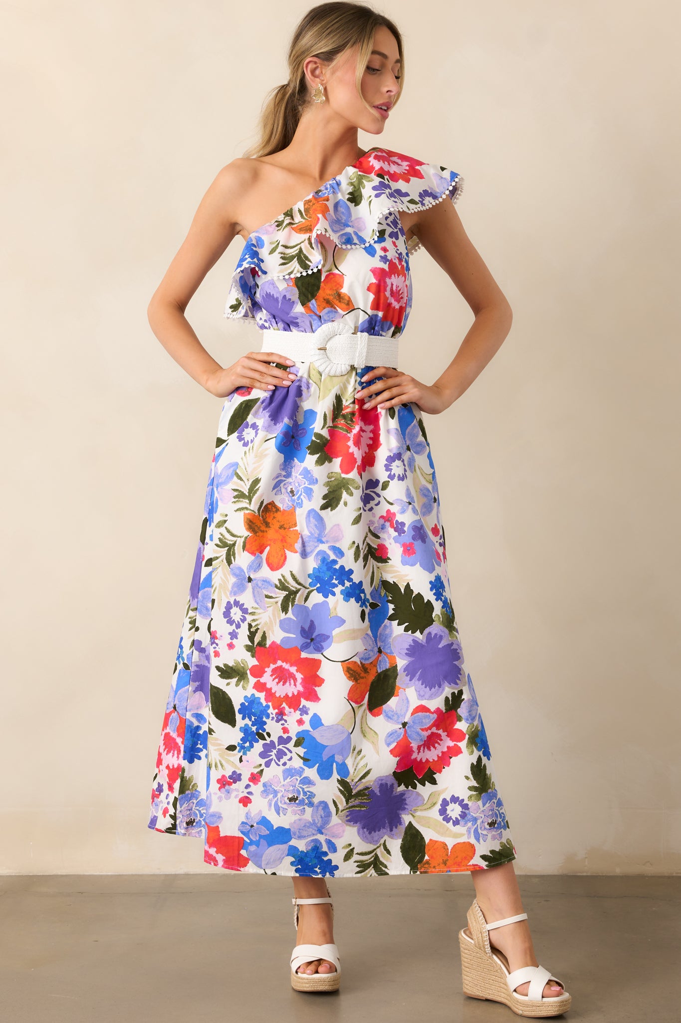 The floral maxi dress showcasing its eyelet trim detailing along the neckline and the flowy, elegant design with an elastic waist for a flattering silhouette.