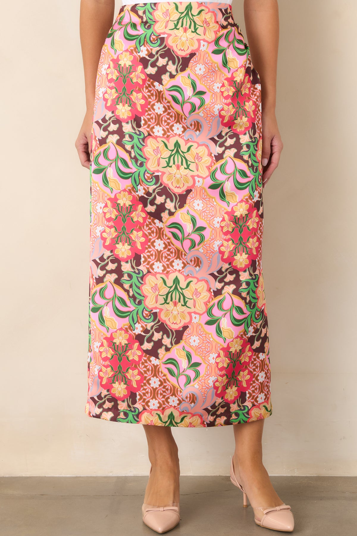 Floral midi skirt highlighting the smooth front waistband and vibrant multicolored medallion pattern.