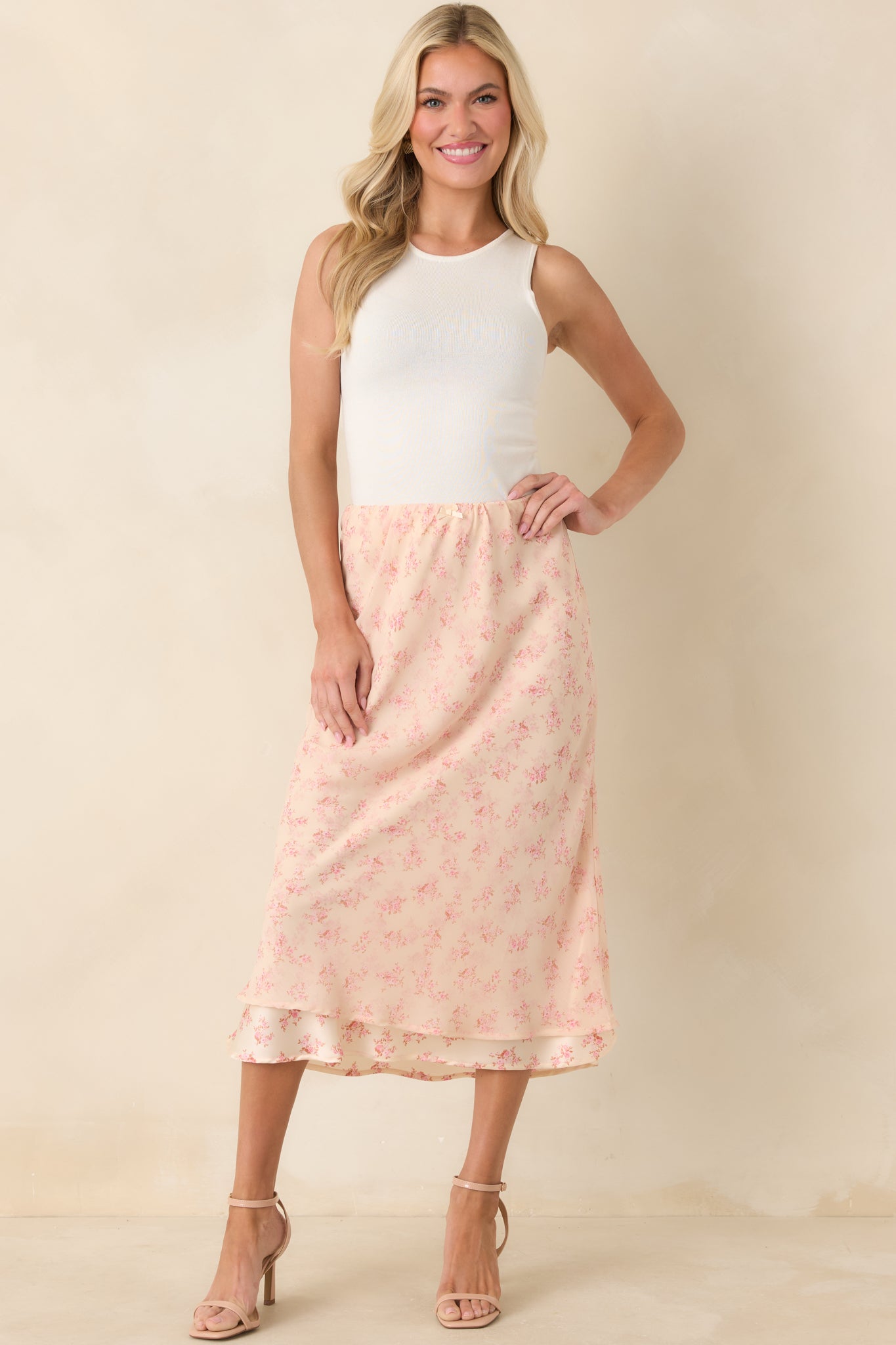 Romantic floral midi skirt designed with a breezy pull-on fit and tiered layers that create graceful, flowing movement.