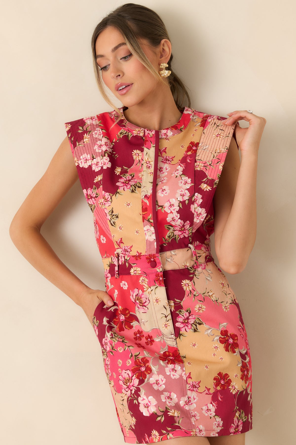Defined waistband with belt loops adds structure above the floral mini dress’s gently flared skirt.