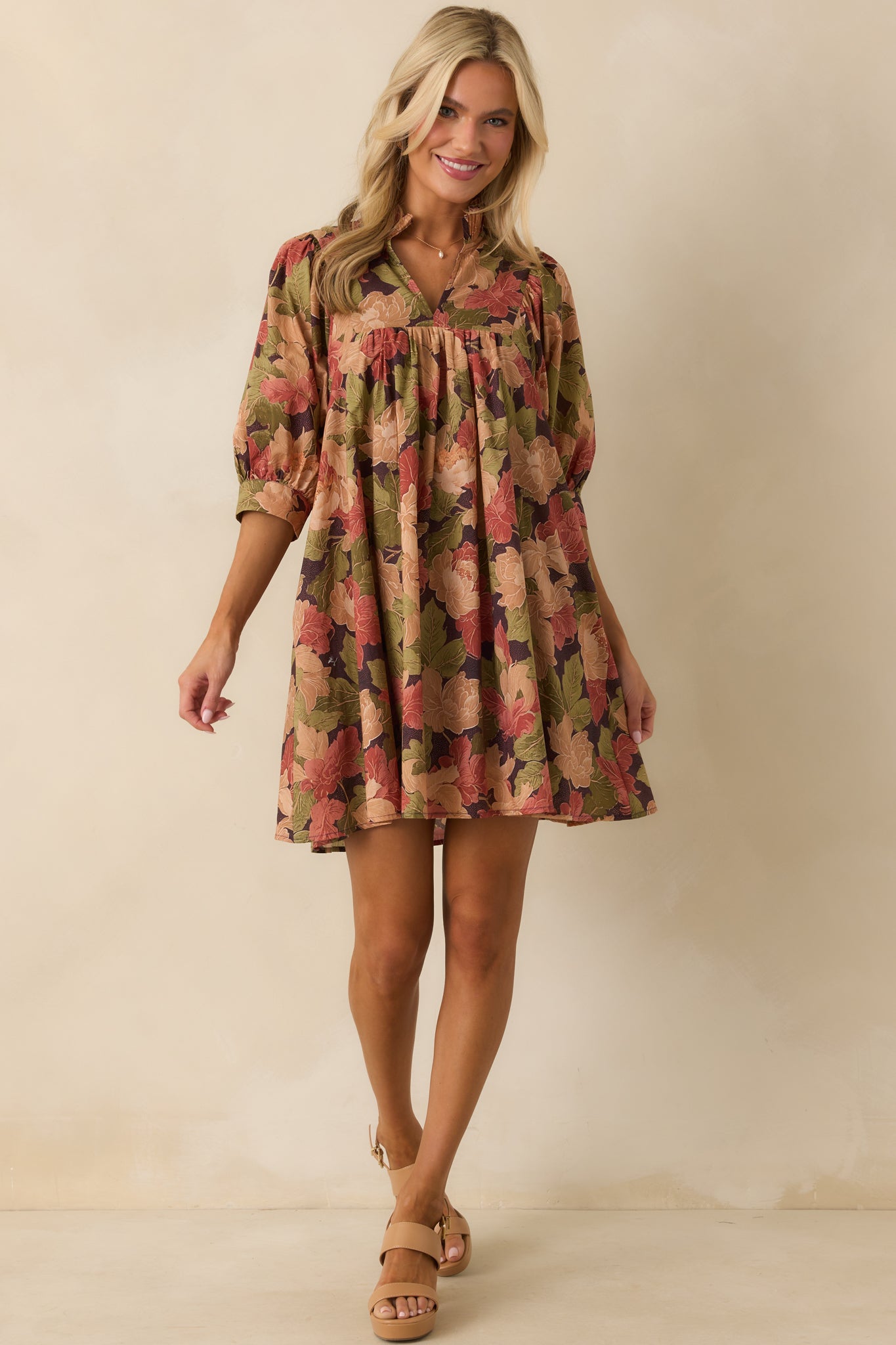 Floral mini dress highlighting puff sleeves, ruffled neckline, and playful hemline.