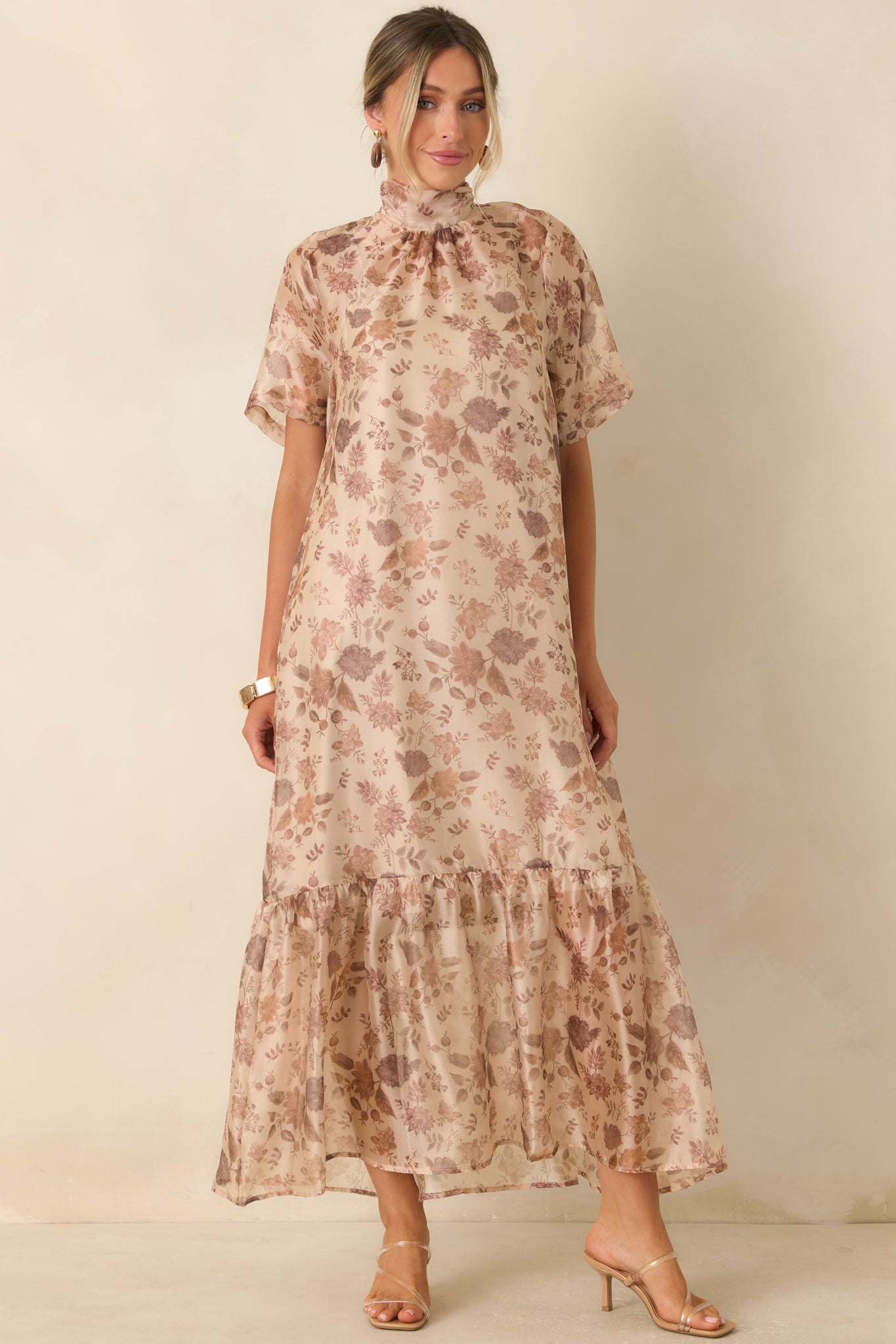 Floral overlay dress featuring a refined mock neckline, layered skirt design, and graceful feminine silhouette.
