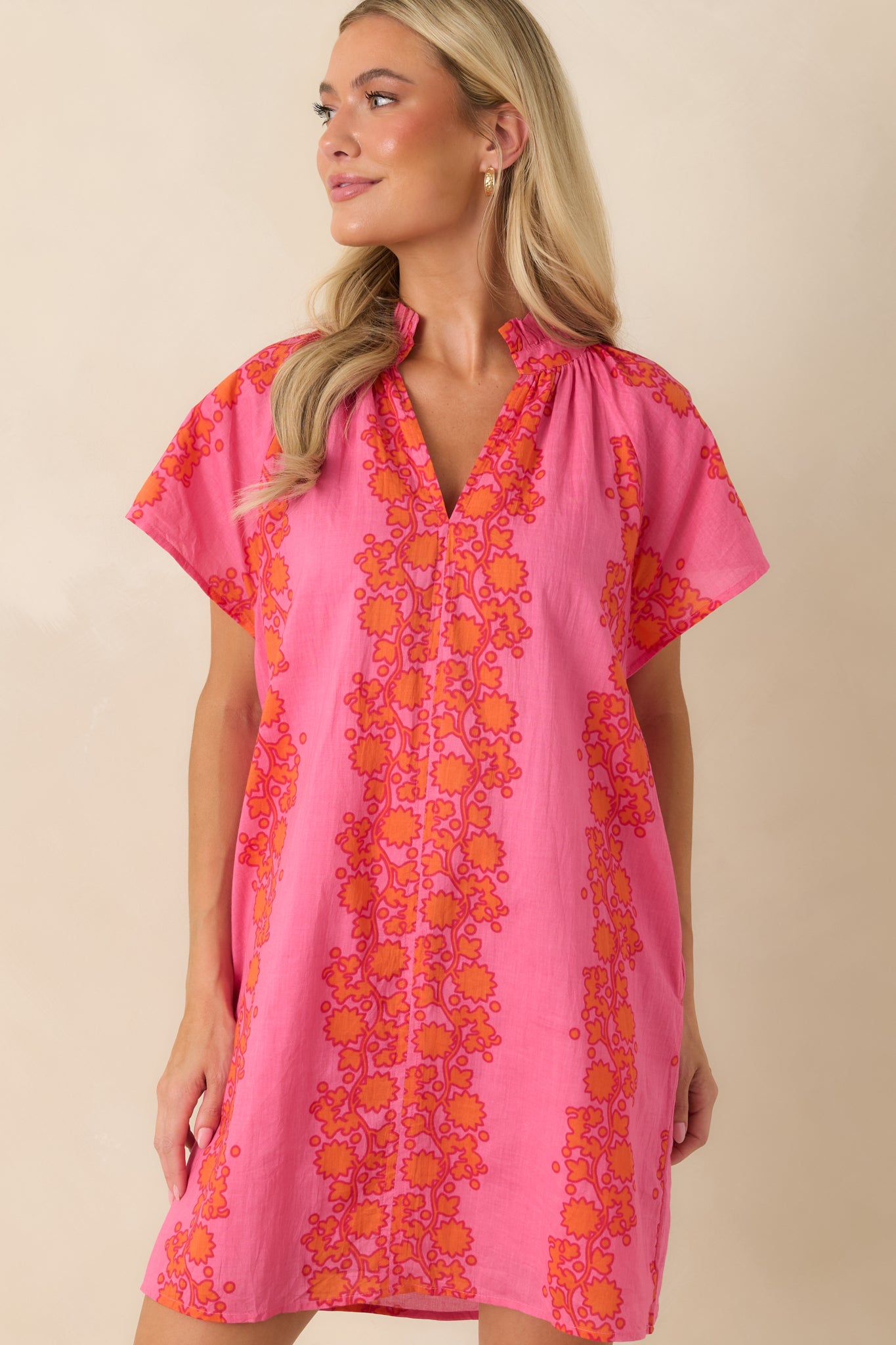 Close-up view of the floral pattern and soft ruffle collar detailing.