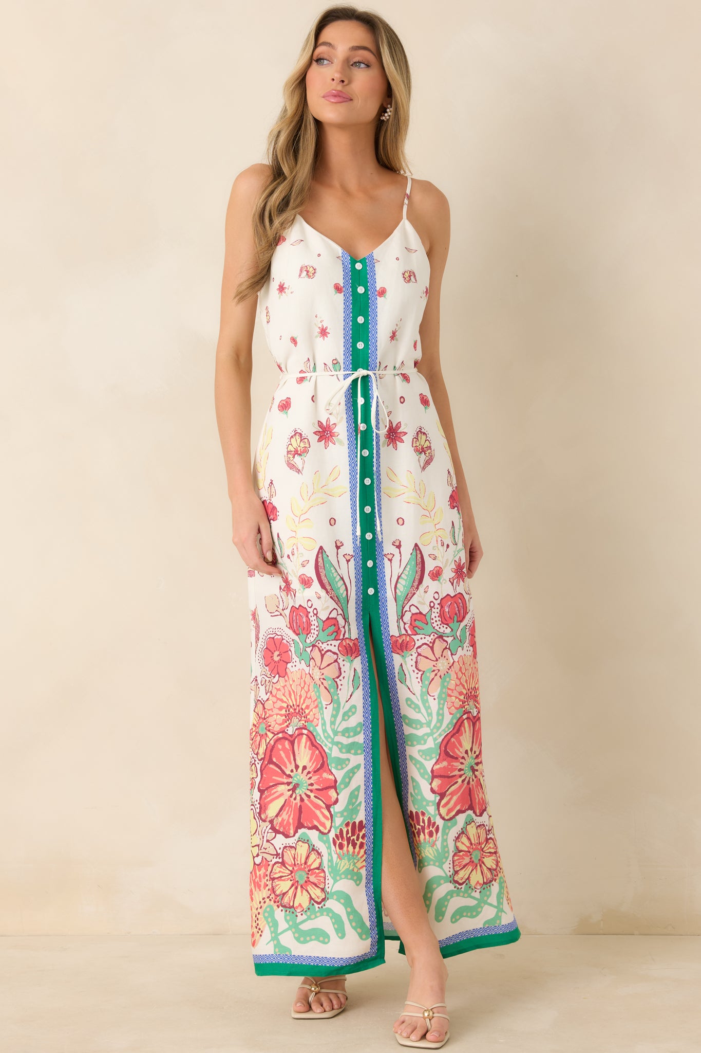 Floral print dress in pink, coral, and green with contrast trim and flowing silhouette.