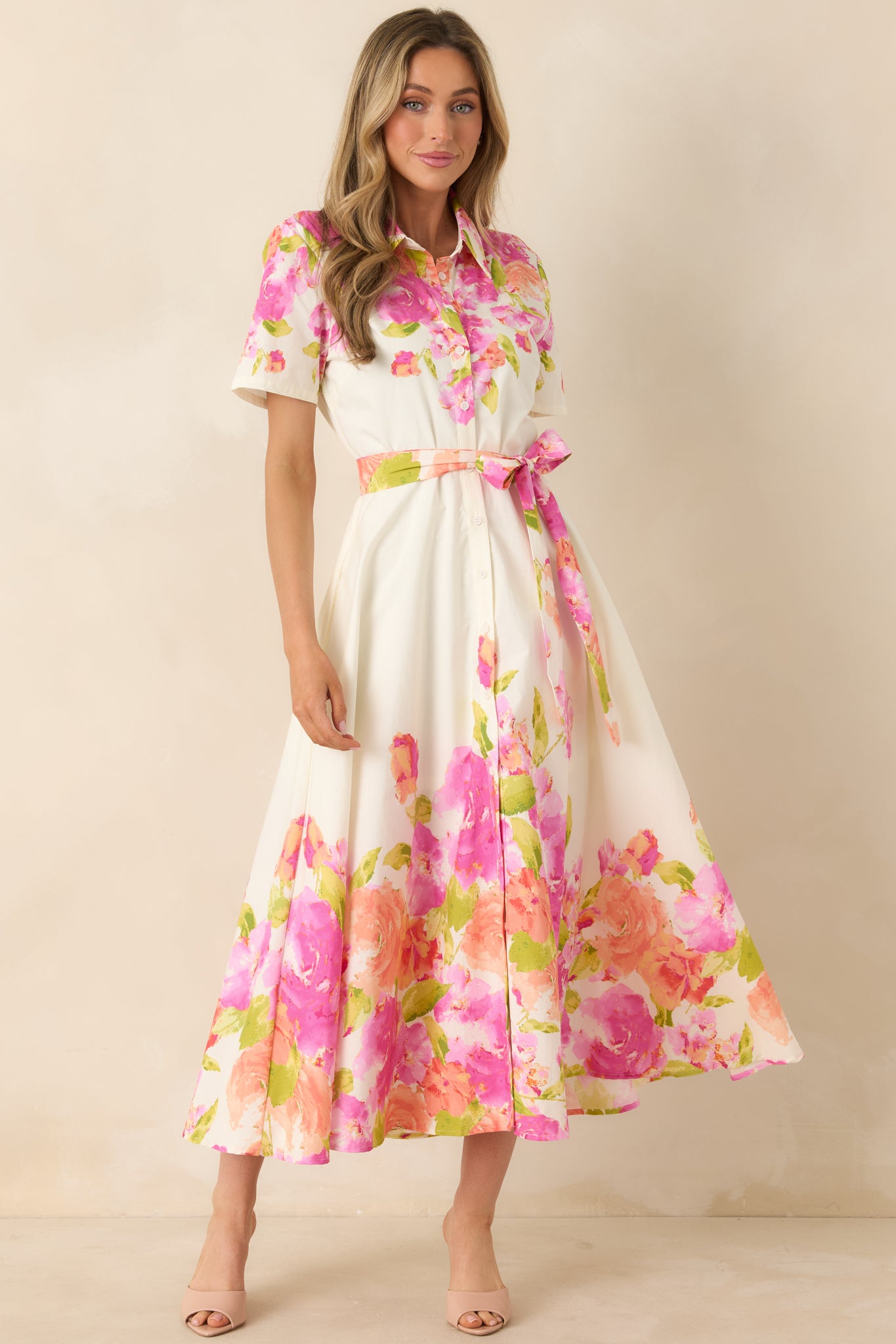 Floral-print dress with short sleeves, button-front design, and side pockets for everyday ease.