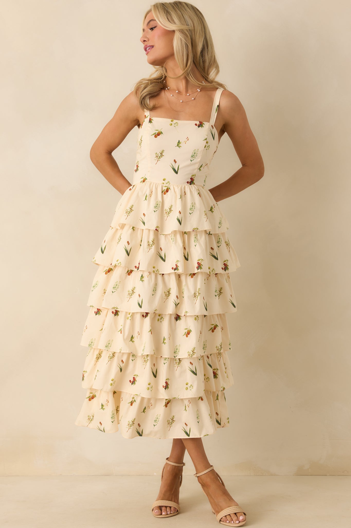 Floral print ivory midi dress with fitted bodice and flowing tiered skirt.