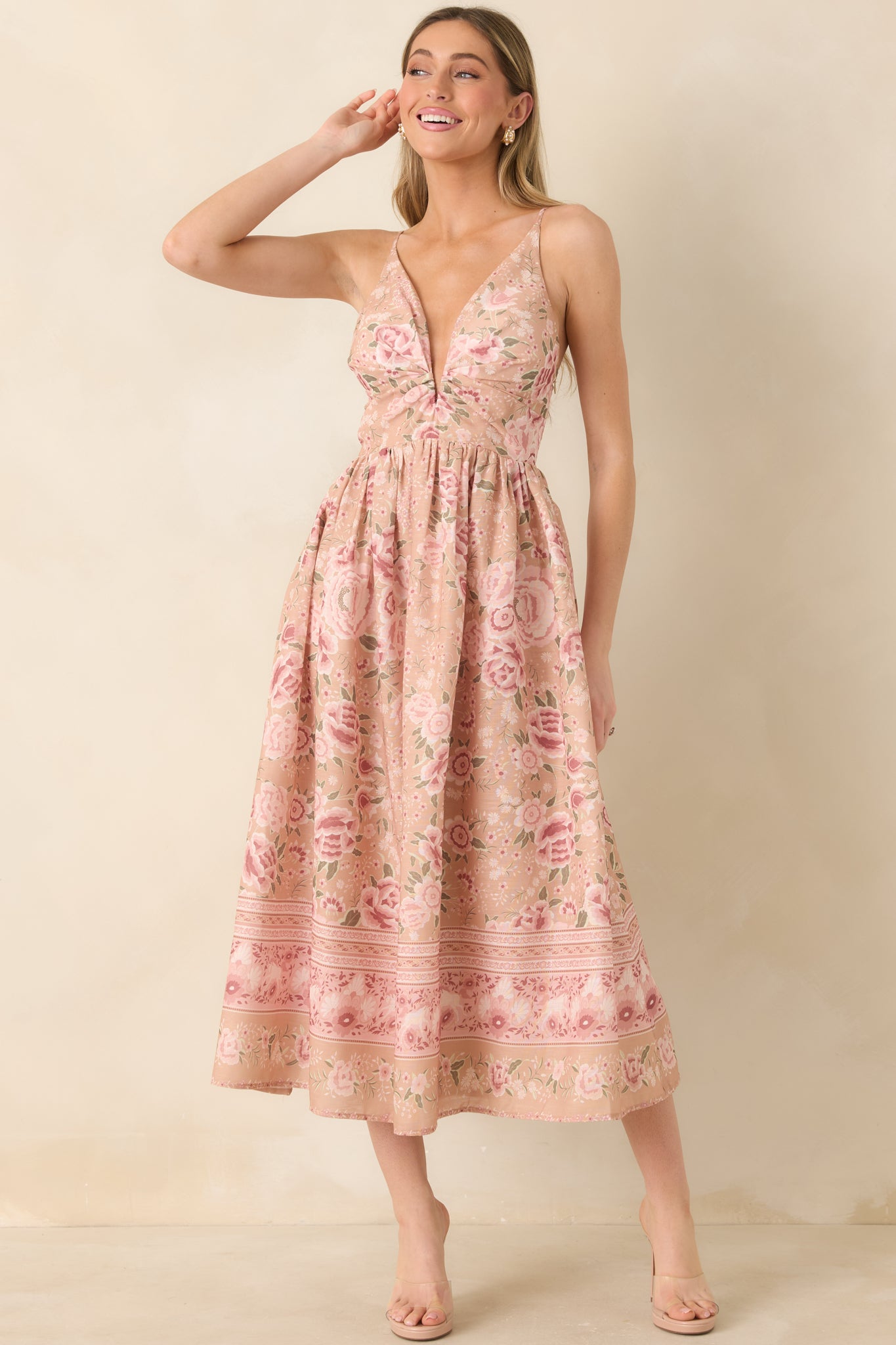 Floral print midi dress featuring a beige base with pink tones and a breezy, fluid shape.