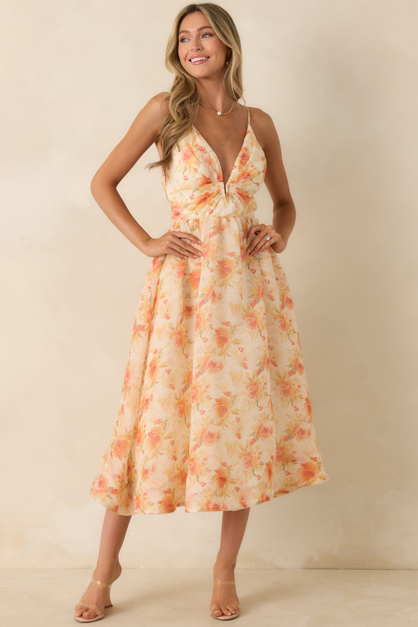 Floral print midi dress with adjustable straps, a relaxed flowing skirt, and vibrant orange-toned watercolor pattern.