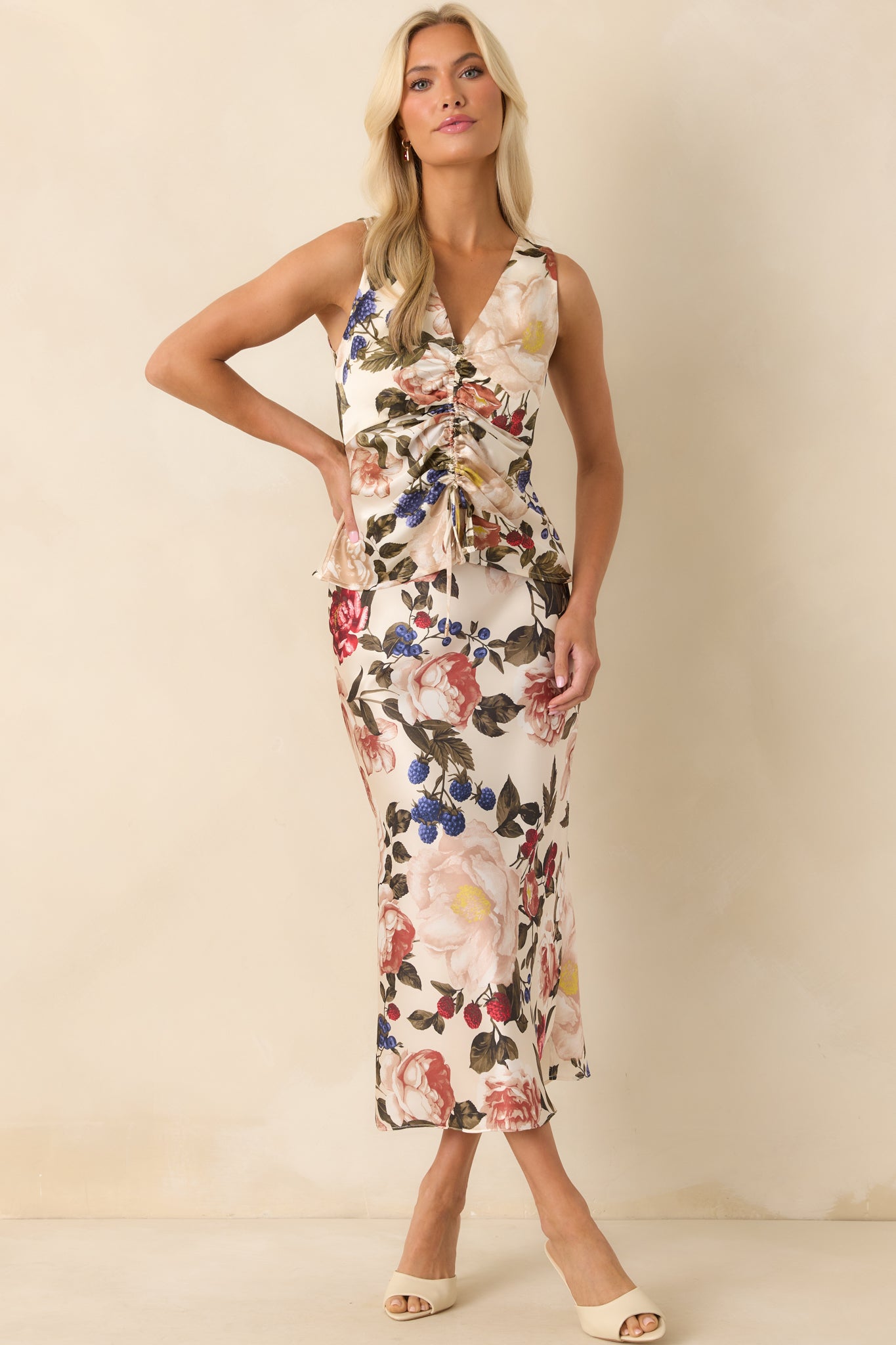 A full-length shot of the ivory skirt featuring a multicolor floral print pattern and high rise fit.