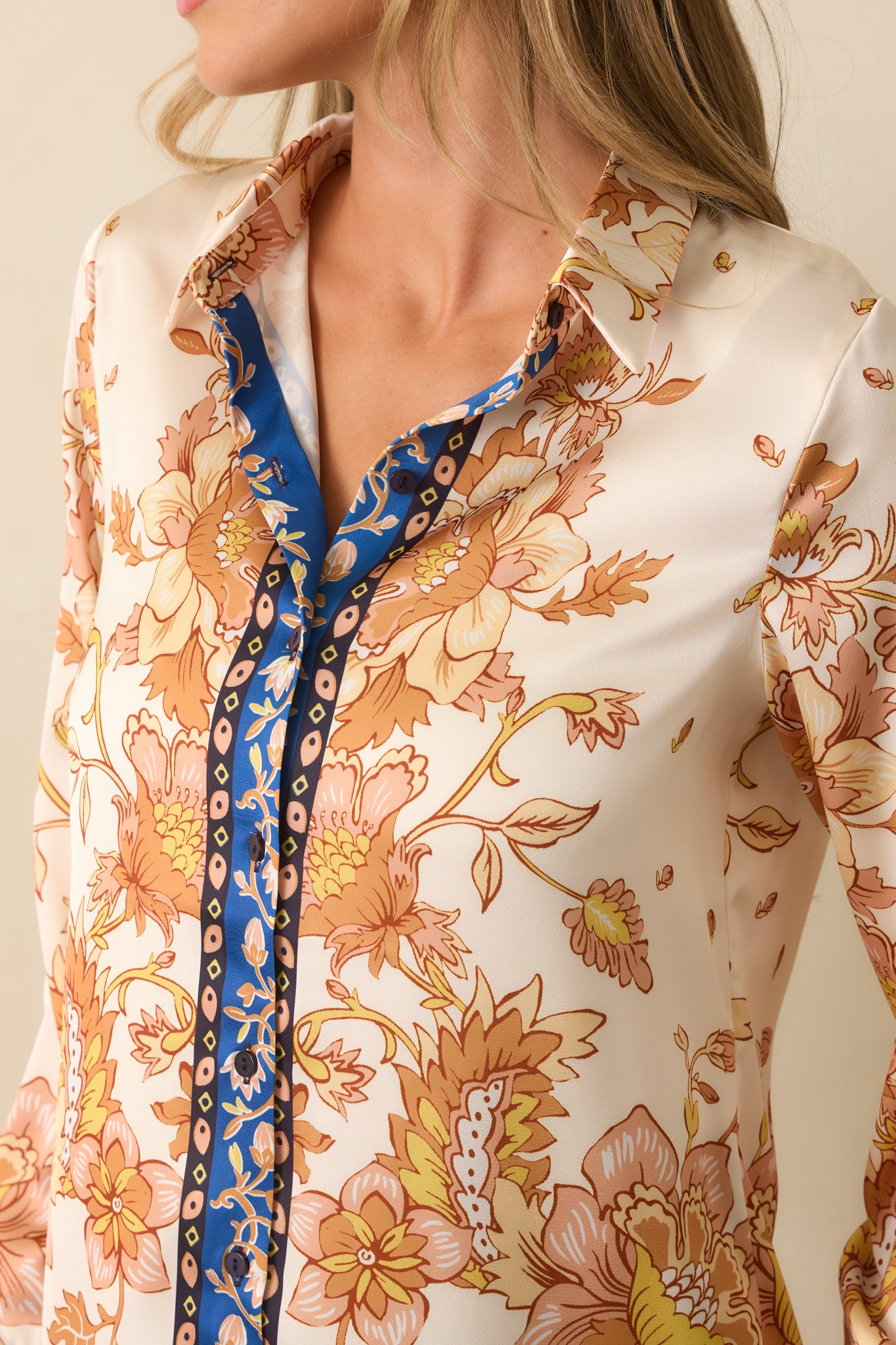 Zoomed-in view of the floral scarf-style print, navy border trim, and satin fabric texture.