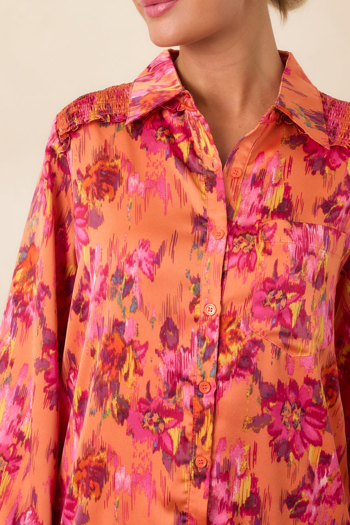 Close-up of the floral satin mini dress highlighting the collared button front, silky sheen, and detailed floral pattern.