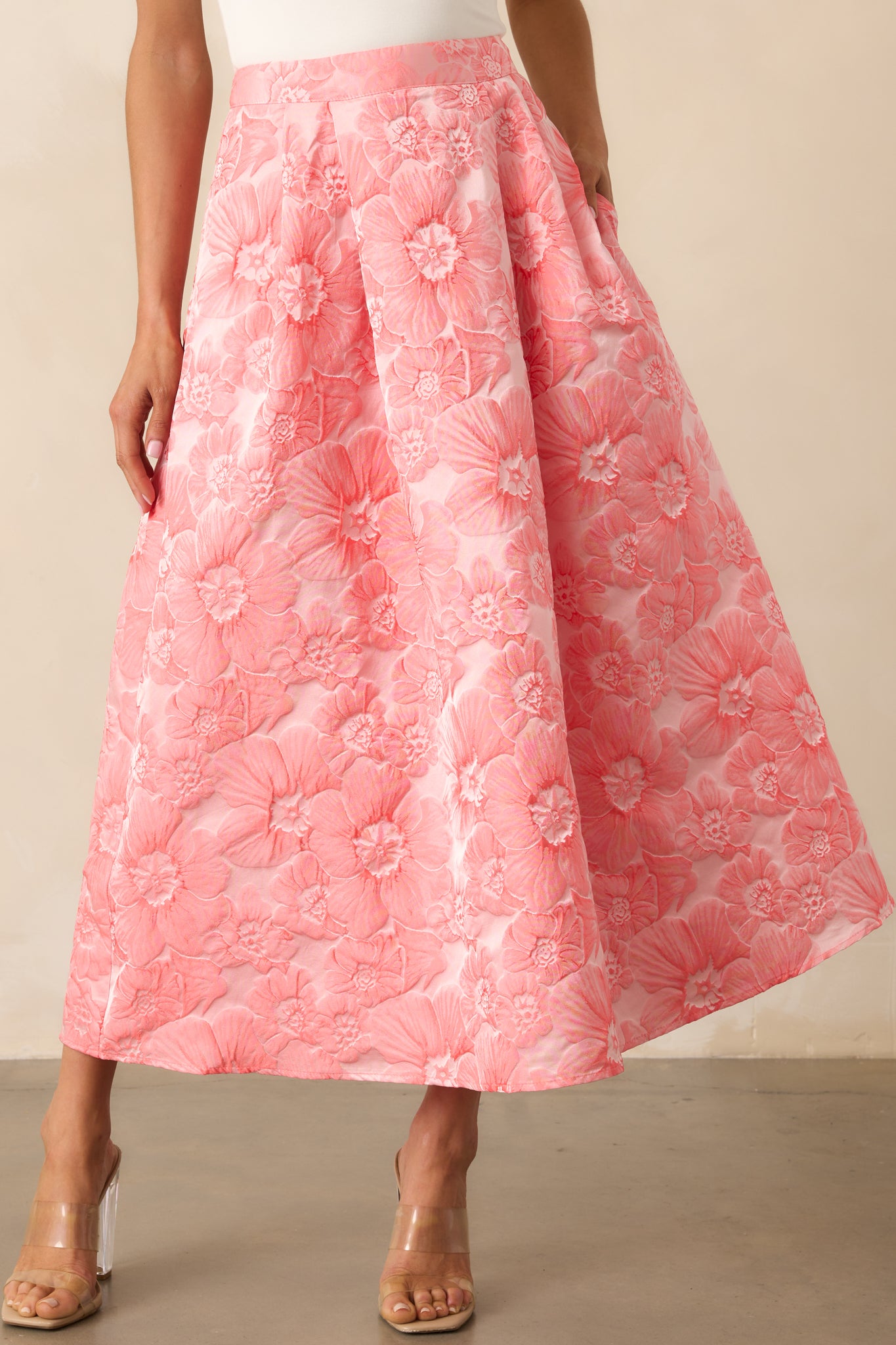 Cropped front view focusing on the waistline and pocket openings, with floral detailing prominently visible.