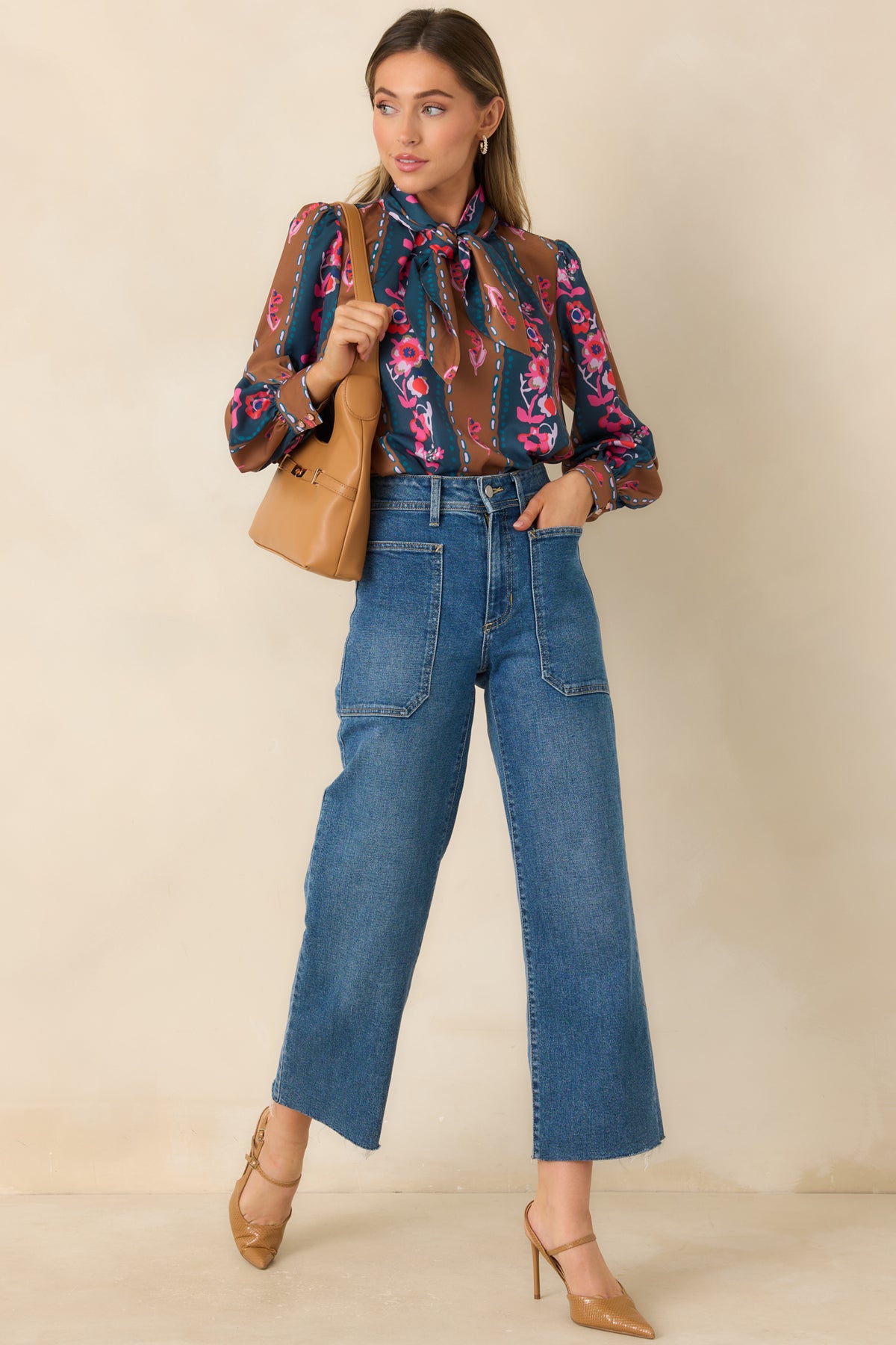 Floral striped top featuring a bow neck tie, softly gathered shoulders, and buttoned sleeve cuffs.