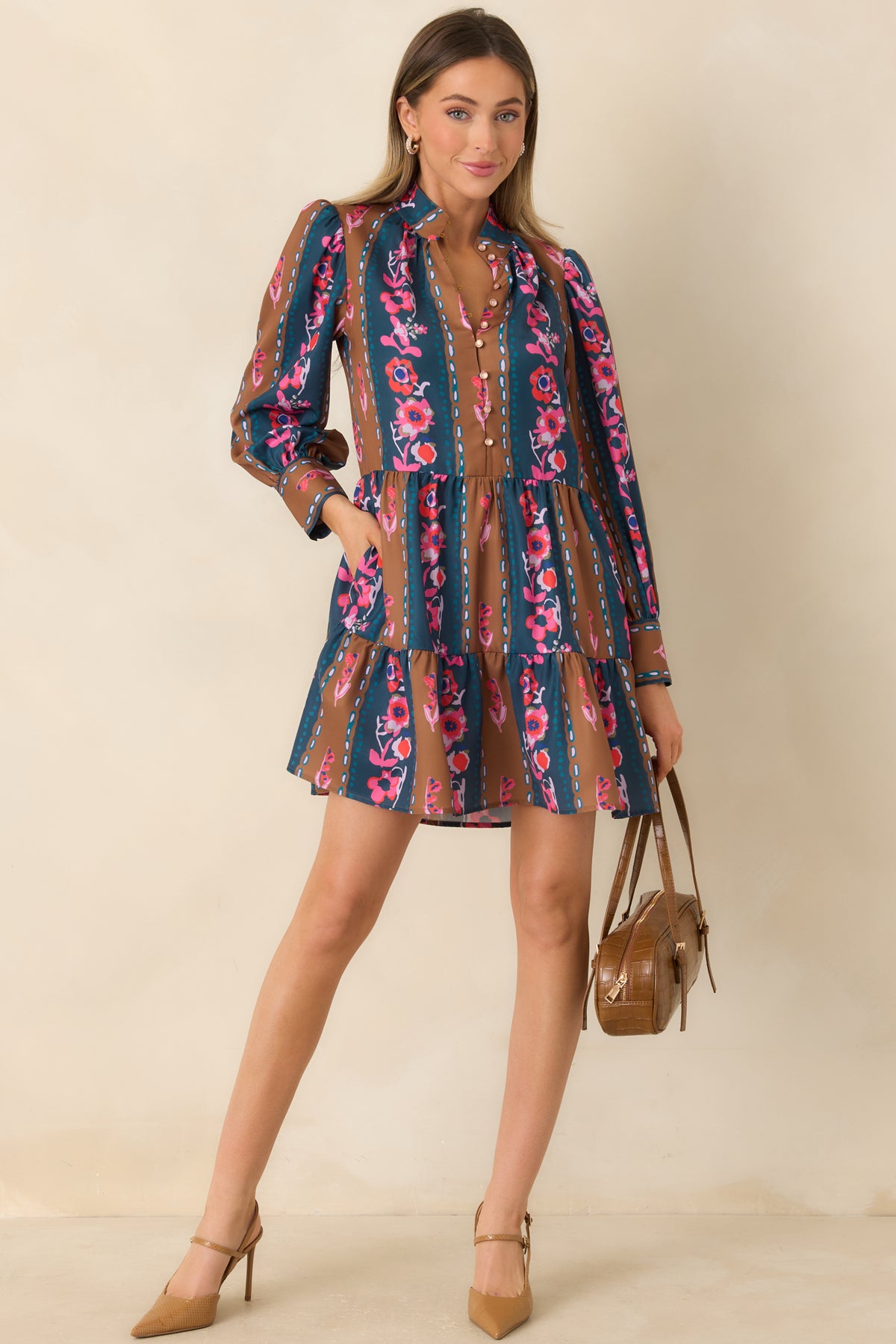 Floral striped mini dress featuring delicate blush buttons, long sleeves, and a relaxed silhouette.