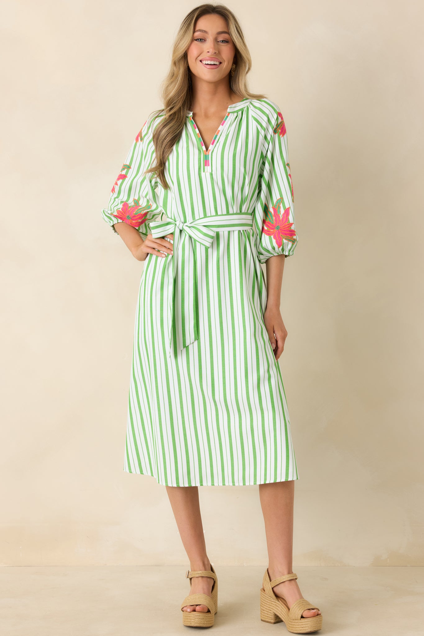 Floral striped midi dress featuring contrast trim neckline and adjustable tie waist.