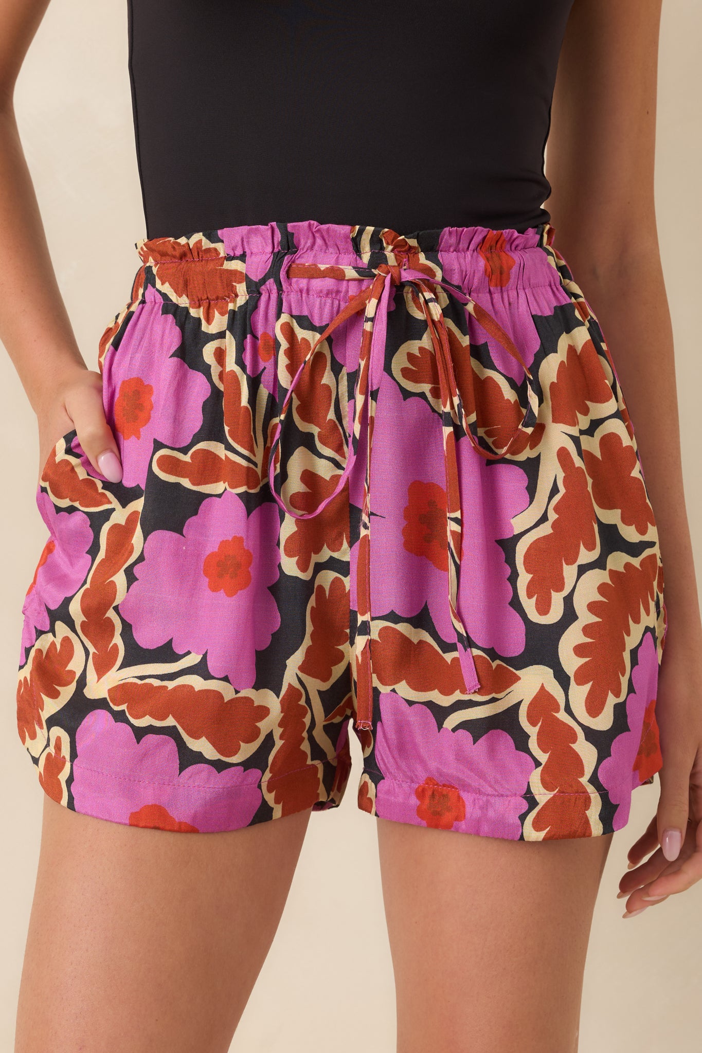 Detailed view of the silky viscose fabric, colorful floral print, and adjustable drawstring waistband.