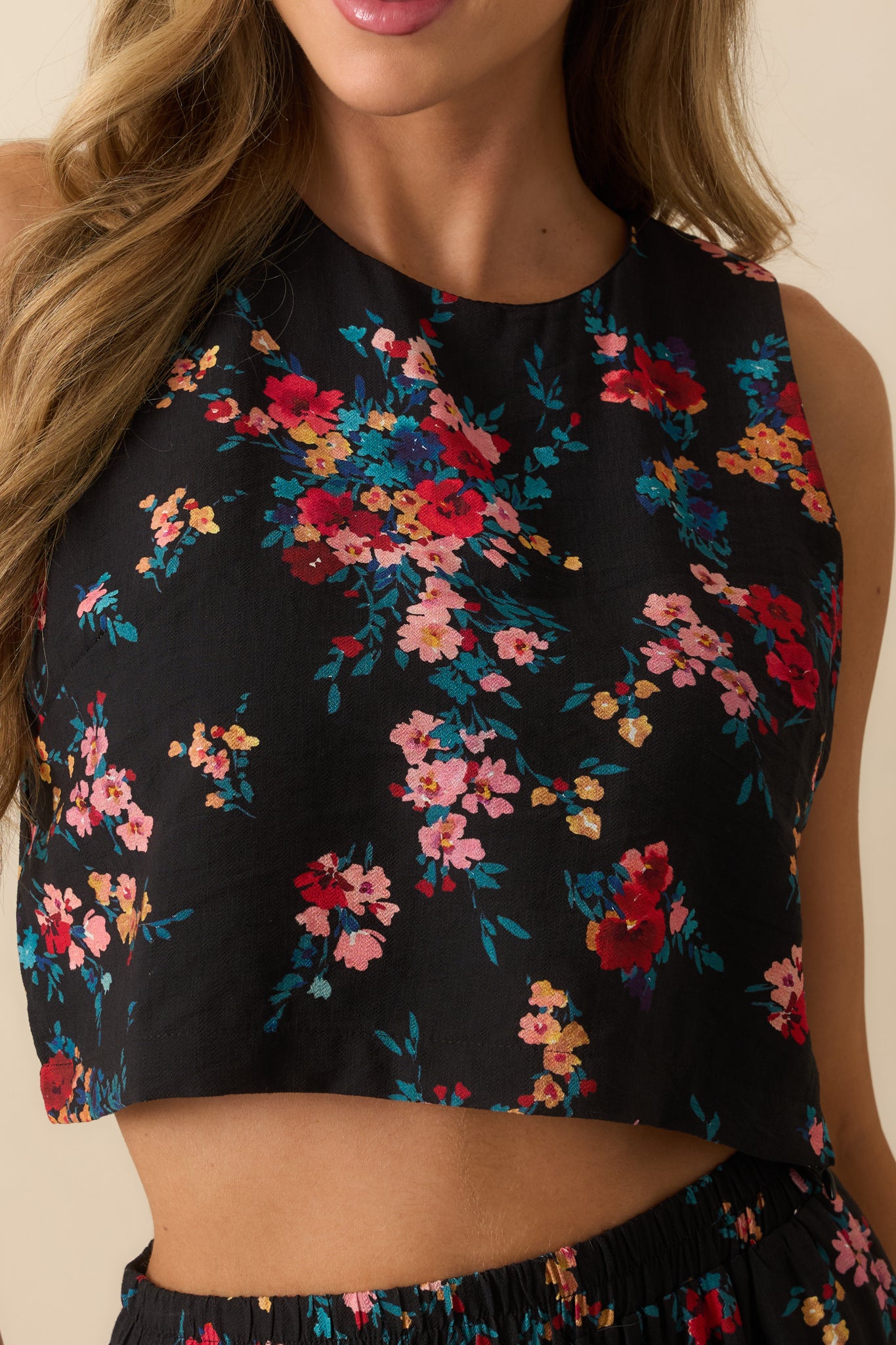 Detailed shot showing the woven fabric, floral print, and neat stitching of the top.