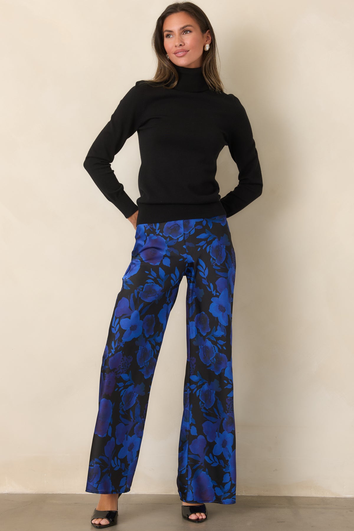 Flowing black wide-leg pants with a subtle satin sheen and vibrant cobalt and violet floral print.