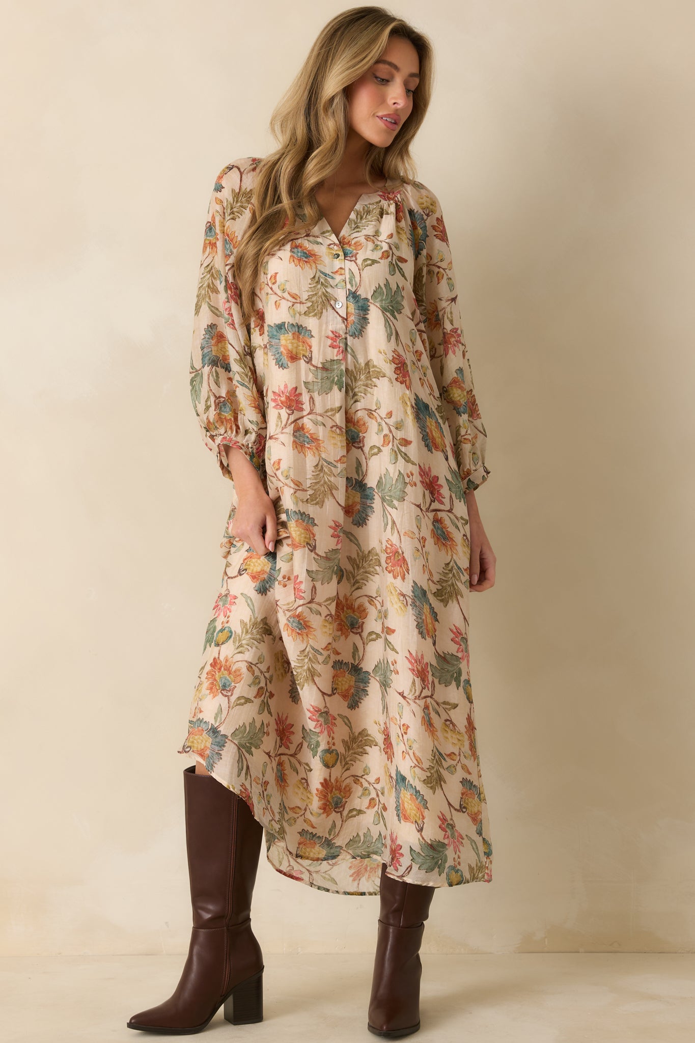 Flowing ecru dress with a delicate multicolor floral pattern, long sleeves, and a comfortable, relaxed fit.
