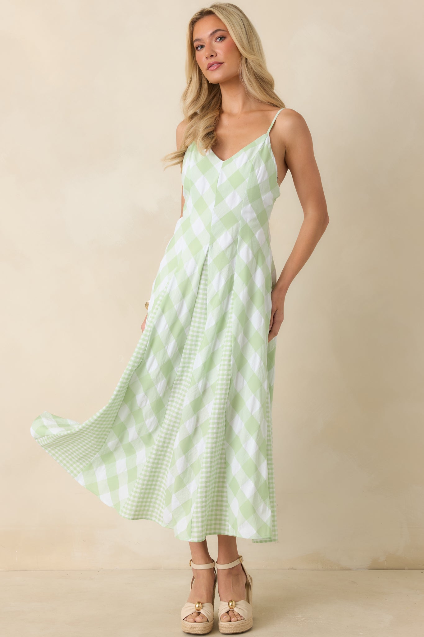 Flowing midi dress with a full skirt, mixed gingham patterns, and a flattering waist-defining shape.