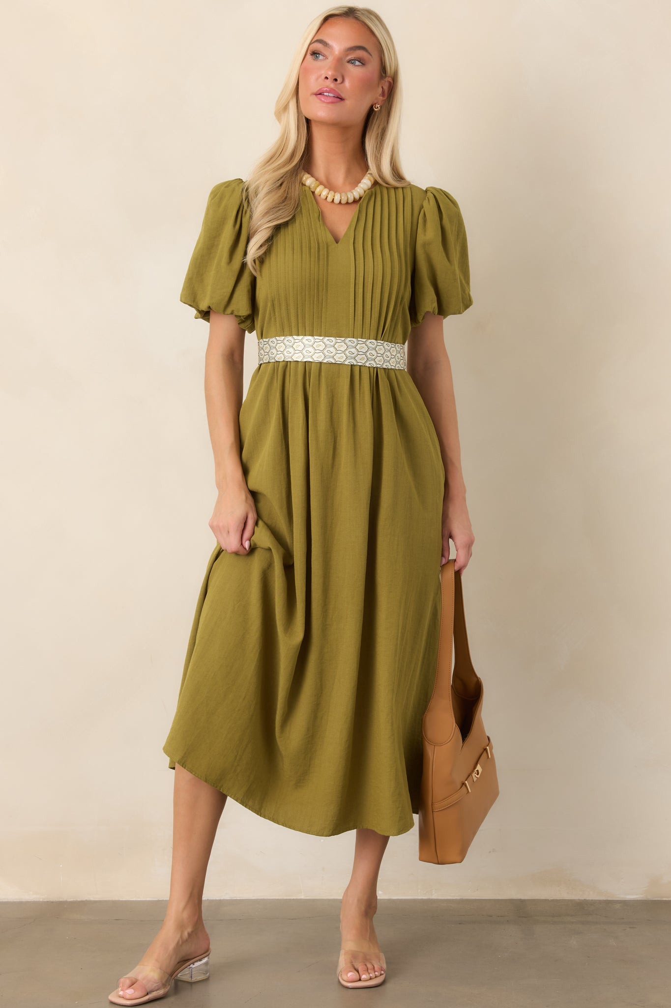 Flowing midi dress with delicate front pintucks, softly gathered puff sleeves, a flattering V-neckline, and a lightweight textured finish.