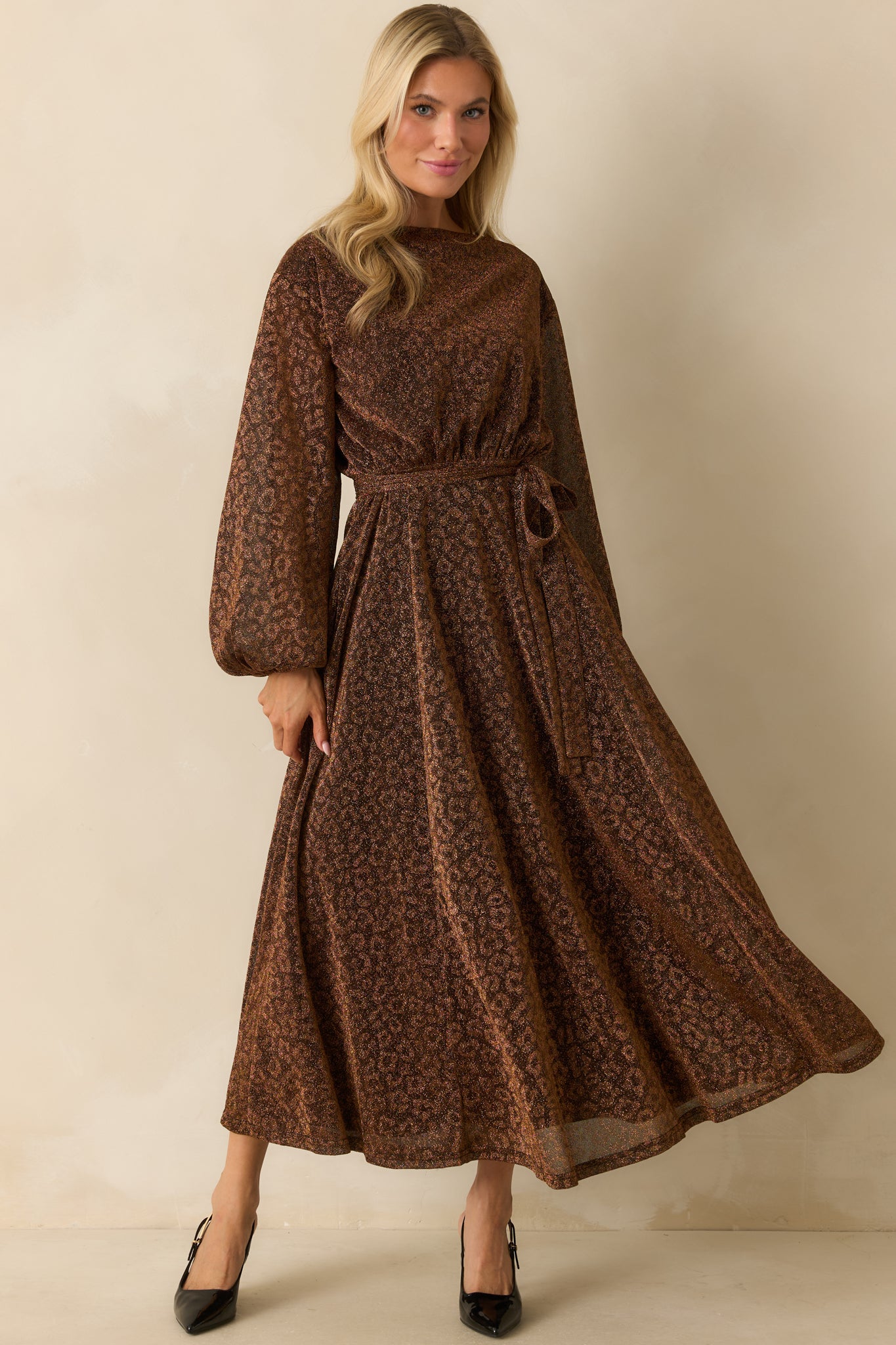 Flowing brown midi dress with subtle shimmer, fitted elastic waist, and gently flared skirt for movement.