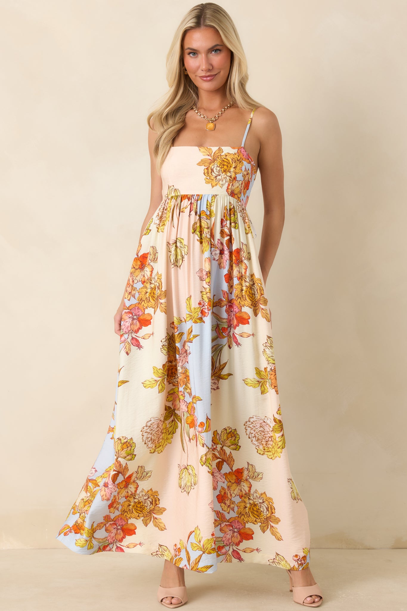 Flowing viscose-blend maxi dress showcasing a soft pastel floral pattern and adjustable spaghetti straps.