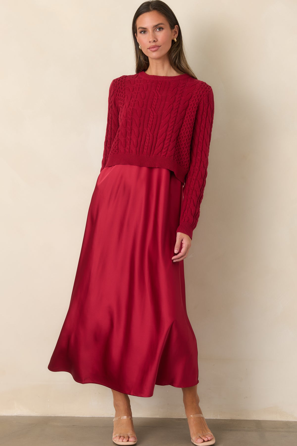 Flowing satin maxi dress paired with a richly textured cropped sweater for a softly layered look.