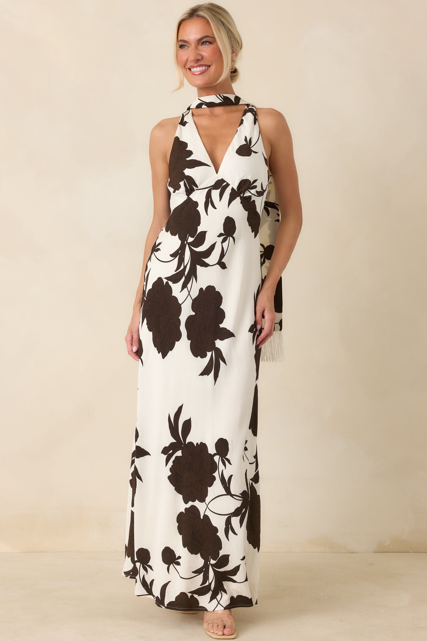 Flowing viscose blend dress featuring a matching scarf accent and graceful full-length silhouette.