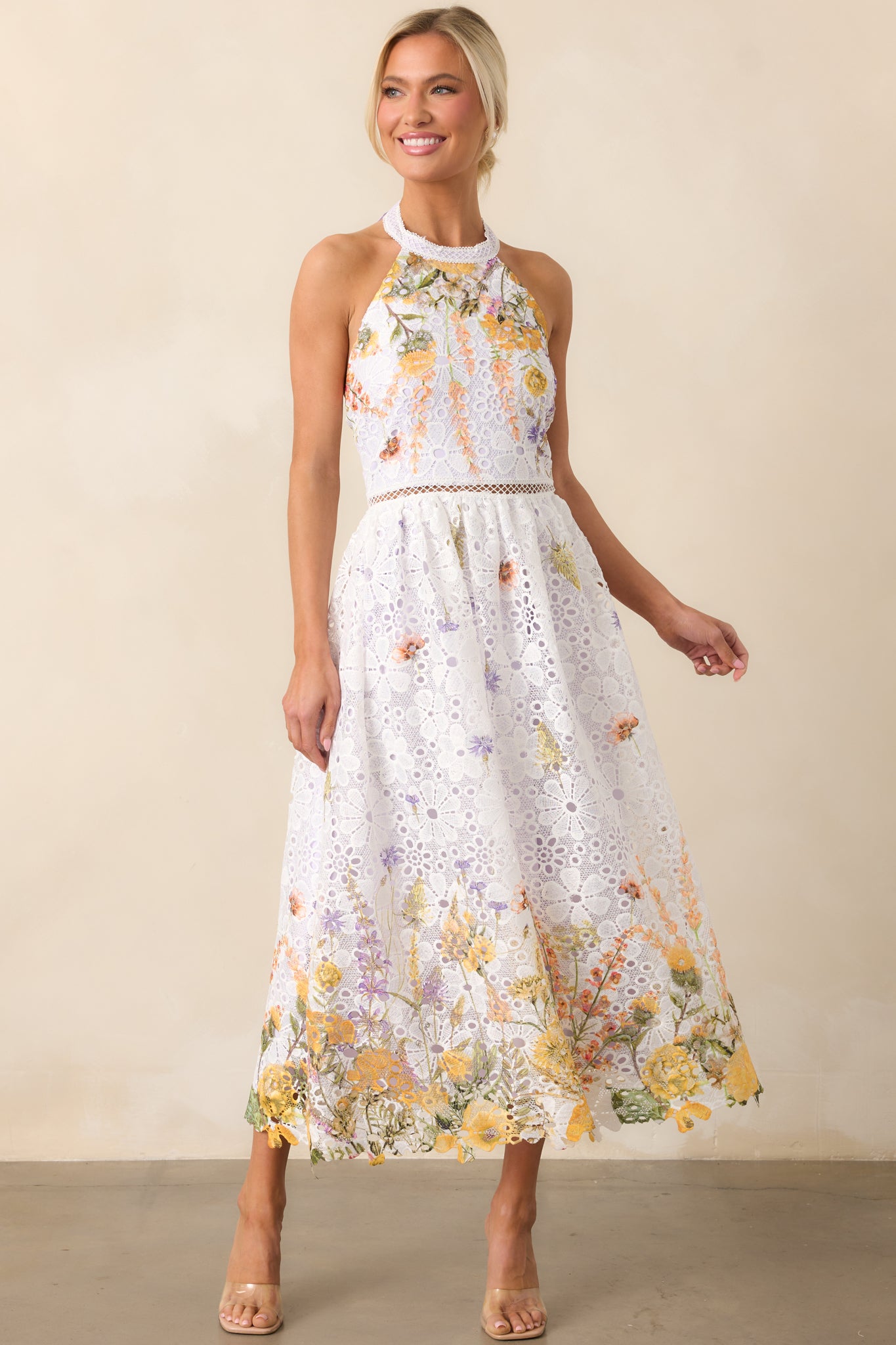 The flowing silhouette of this midi dress is complemented by its floral embroidery and soft lavender lining.