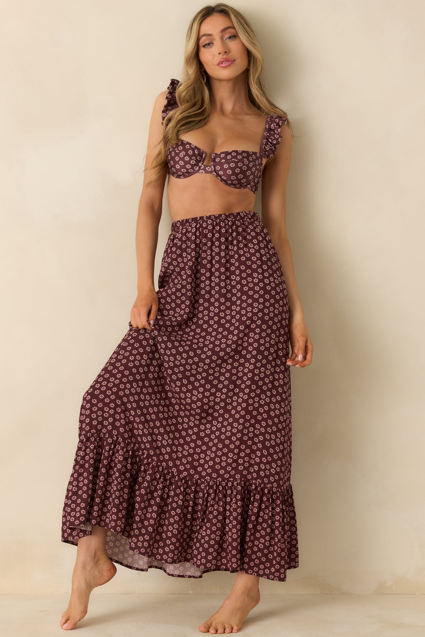 Flowy burgundy skirt showing its elastic waistband and easy movement in the woven fabric.