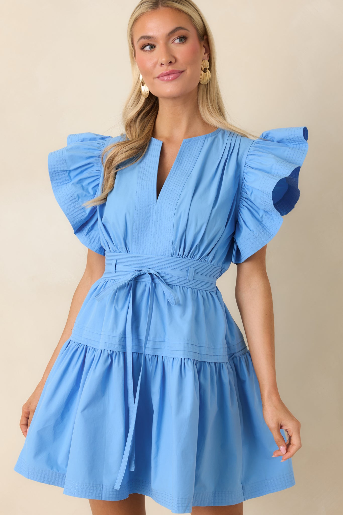 Flutter sleeve detail on mini dress with airy tiered skirt
