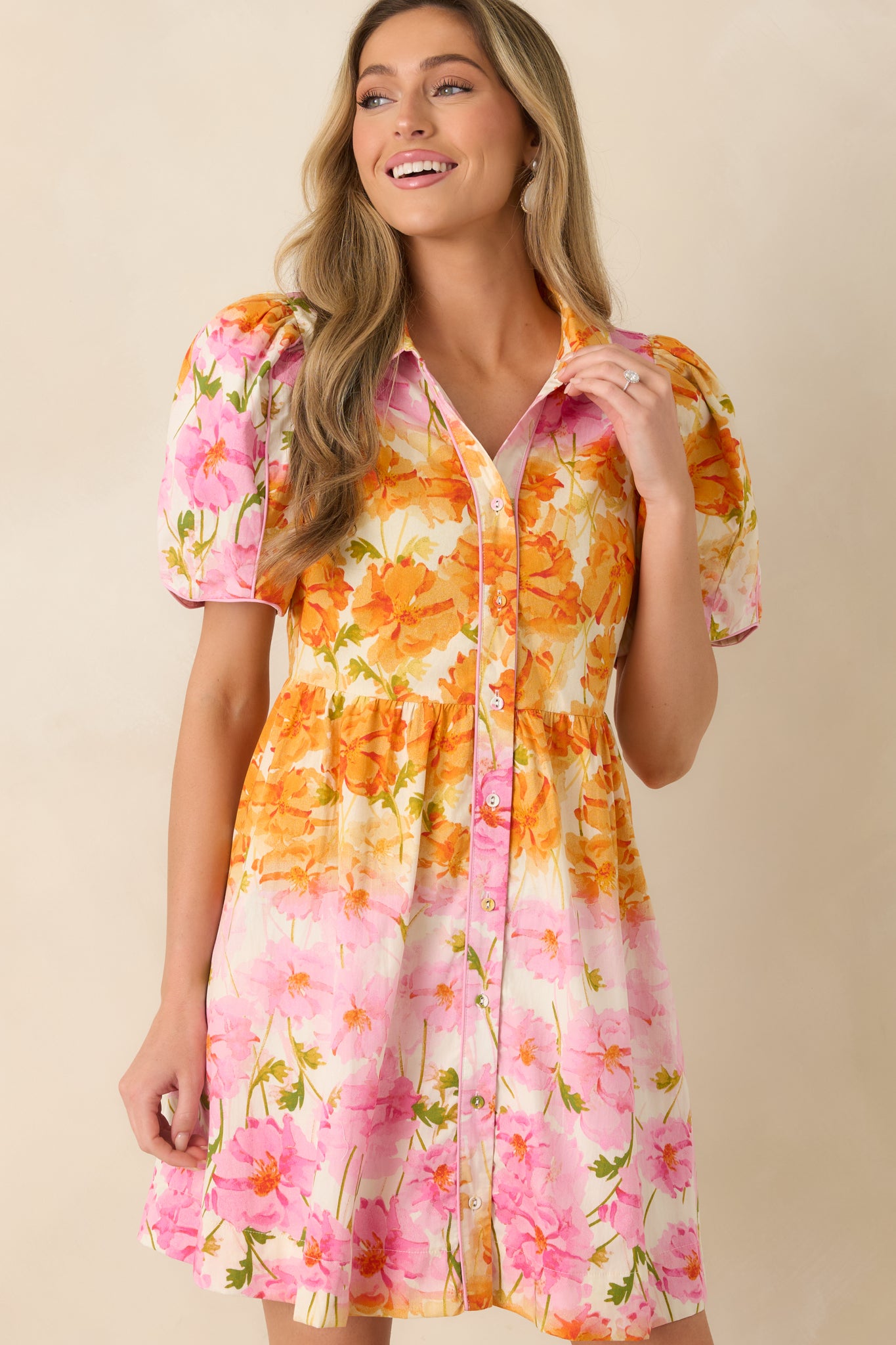 Focused detail of the collar and front buttons accented with delicate pink piping.
