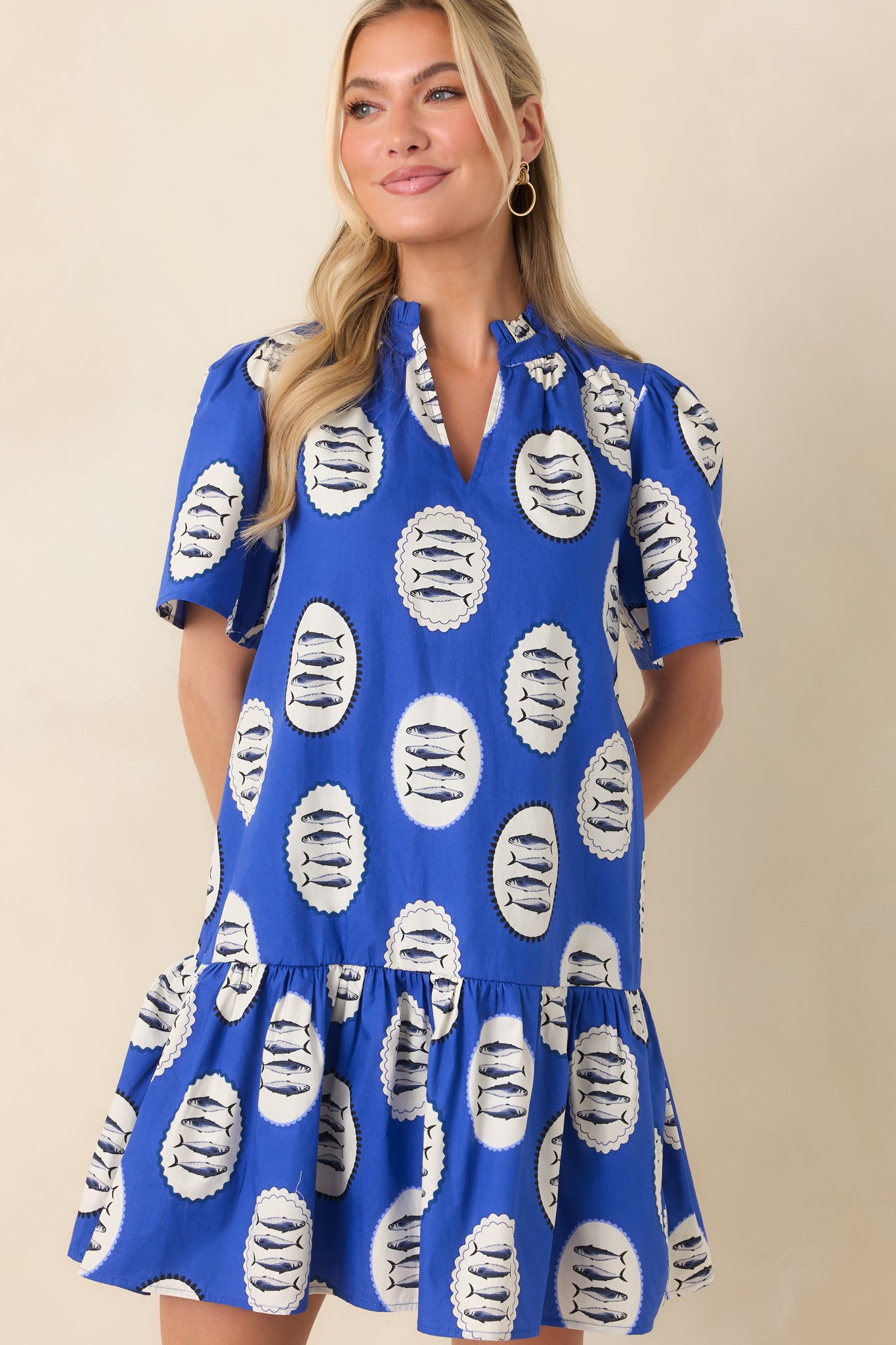 Focused view showing the gathered tiered hem and structured neckline of the playful royal blue mini dress.