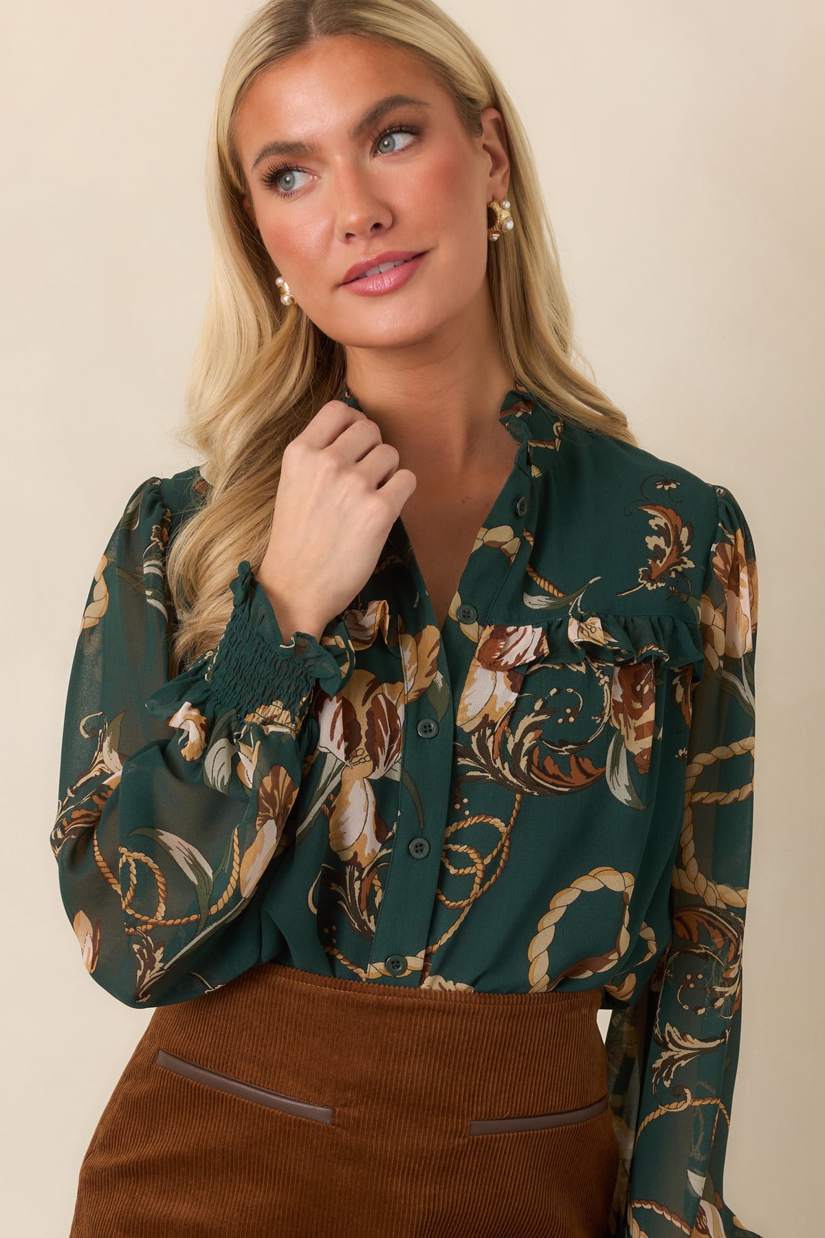 Forest green top highlighting its camel, cream, and brown floral and rope-inspired print.