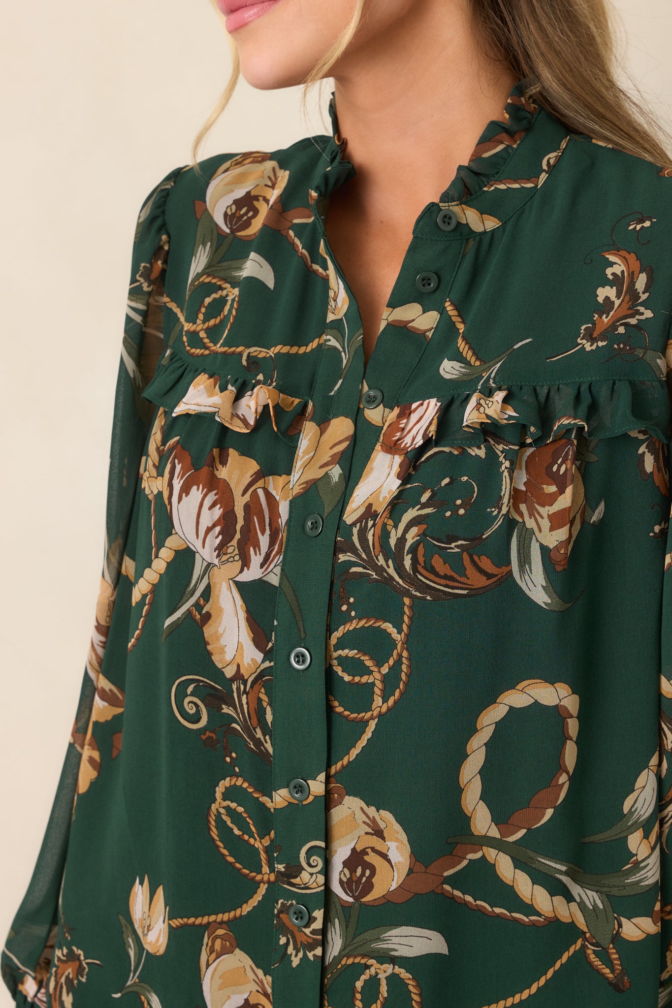 Detailed view highlighting the forest green ruffle-trimmed yoke, functional buttons, and softly gathered neckline.