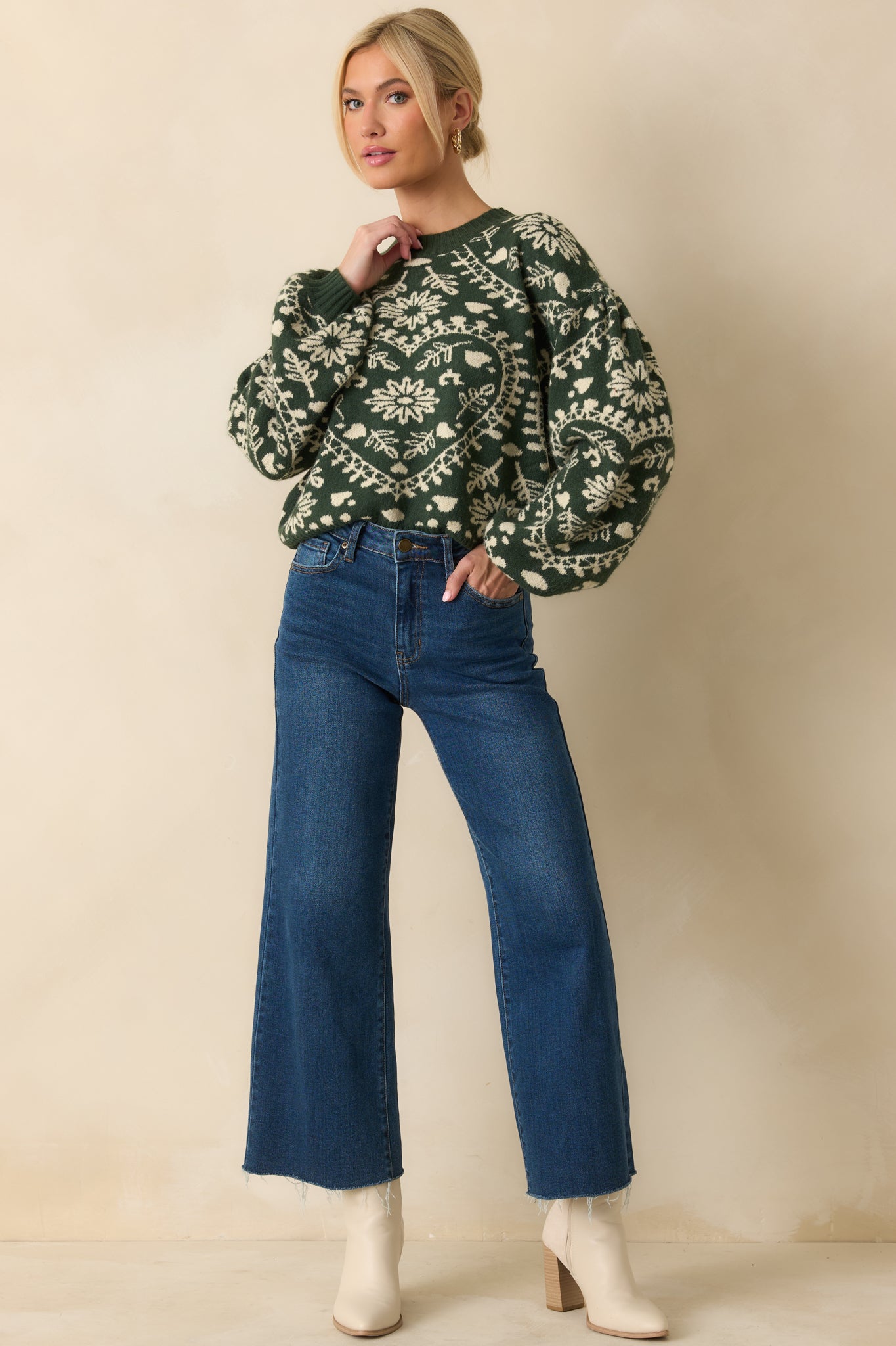 Forest green sweater with a crew neckline, drop shoulders, long balloon sleeves, and ribbed cuffs and hem, featuring a subtle heart pattern.