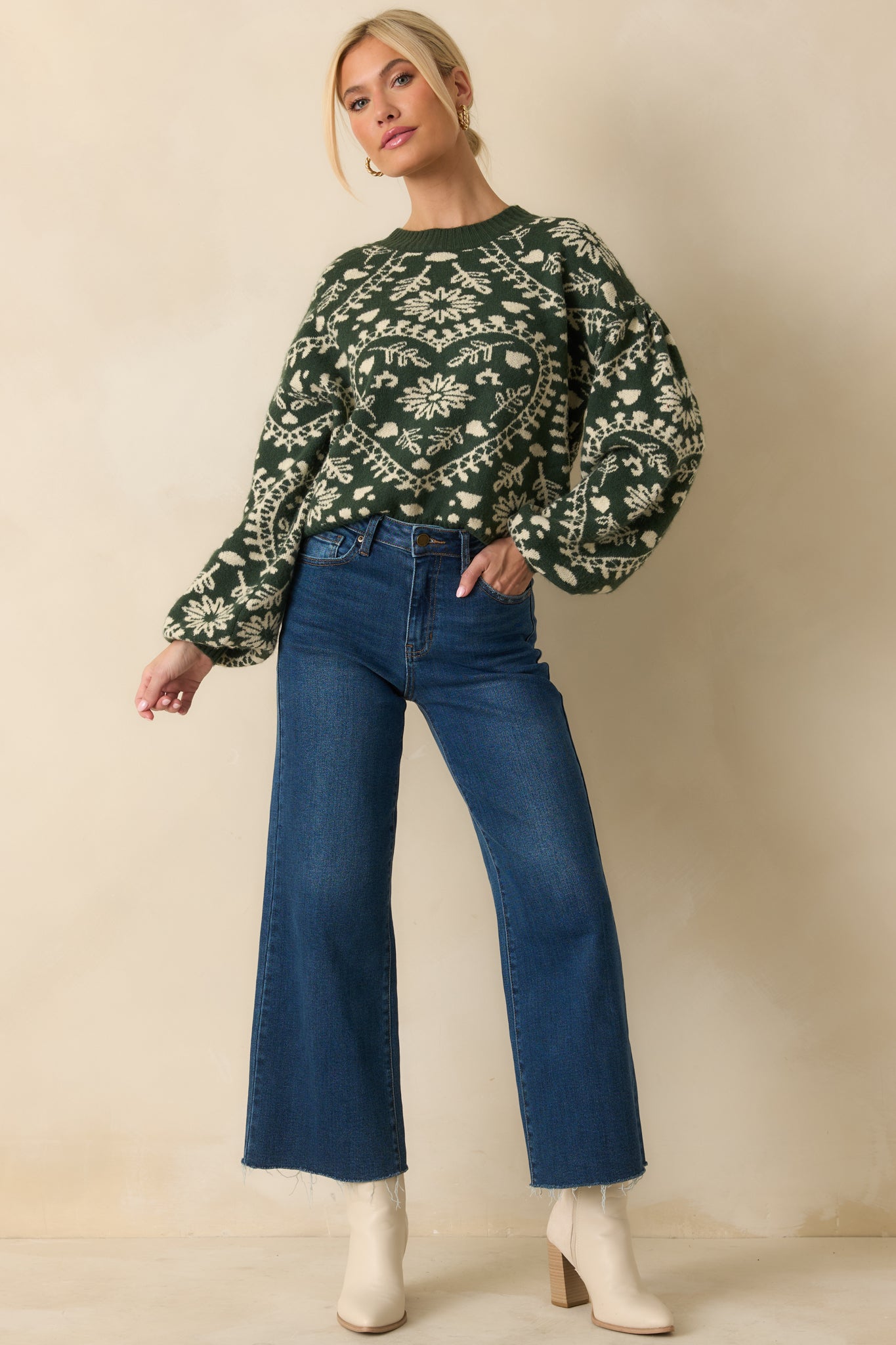Soft knit forest green sweater with a relaxed fit, crew neckline, and ribbed hem and cuffs, adorned with heart motifs.
