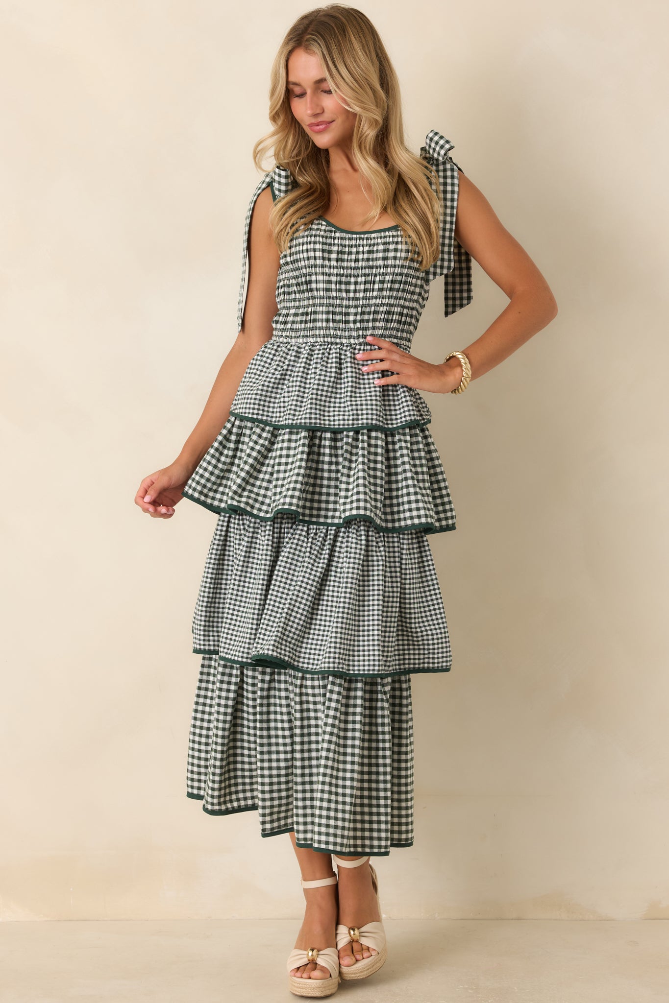Feminine dress showcasing four full tiers, coordinating green edging, scoop neckline, and soft movement.