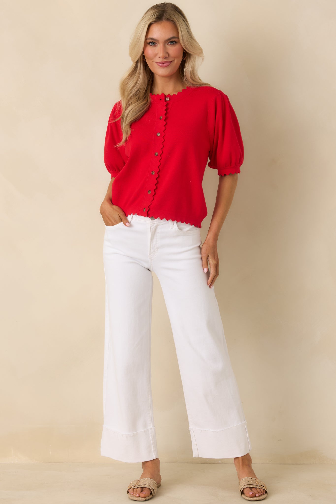 Straight-on front angle highlighting the button placket framed by scalloped edging and the round neckline.