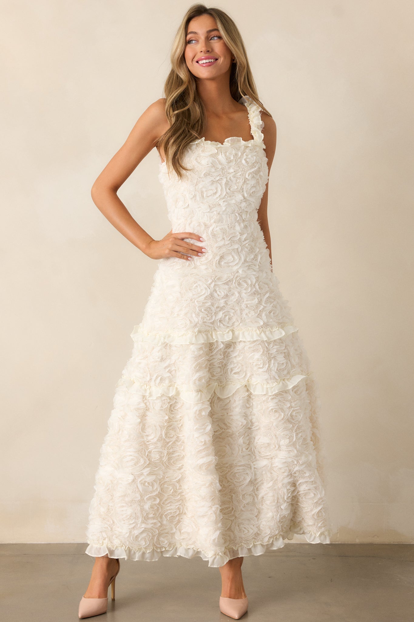 The ivory dress from a slight front angle, showcasing the square neckline and detailed floral appliques on the bodice.