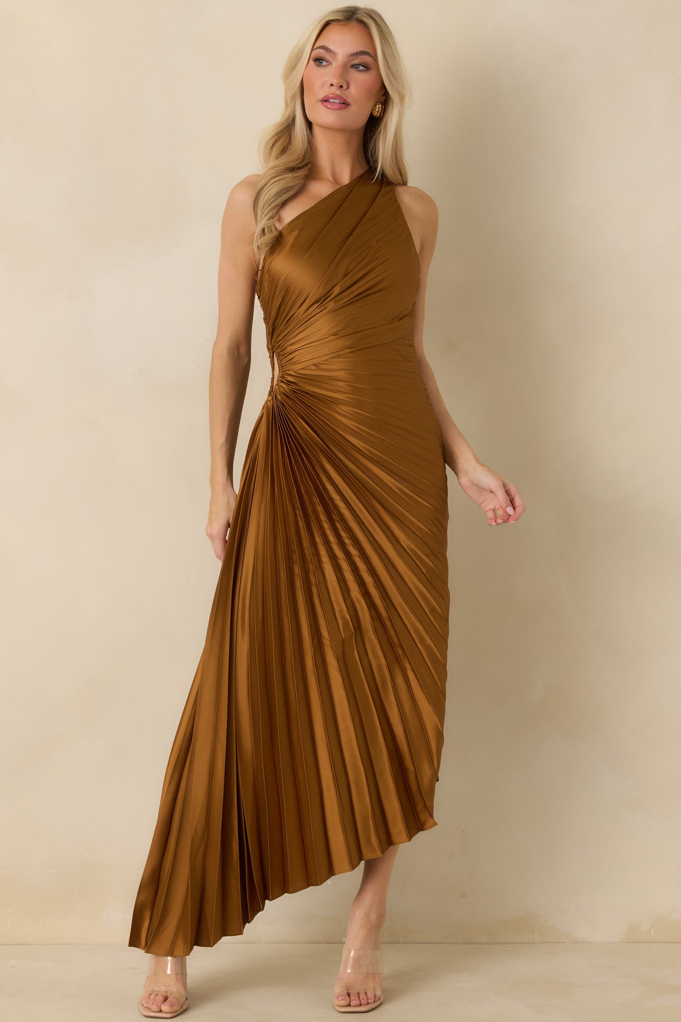 Front-facing angle of bronze one-shoulder maxi dress highlighting the fitted bodice and small side cutout.