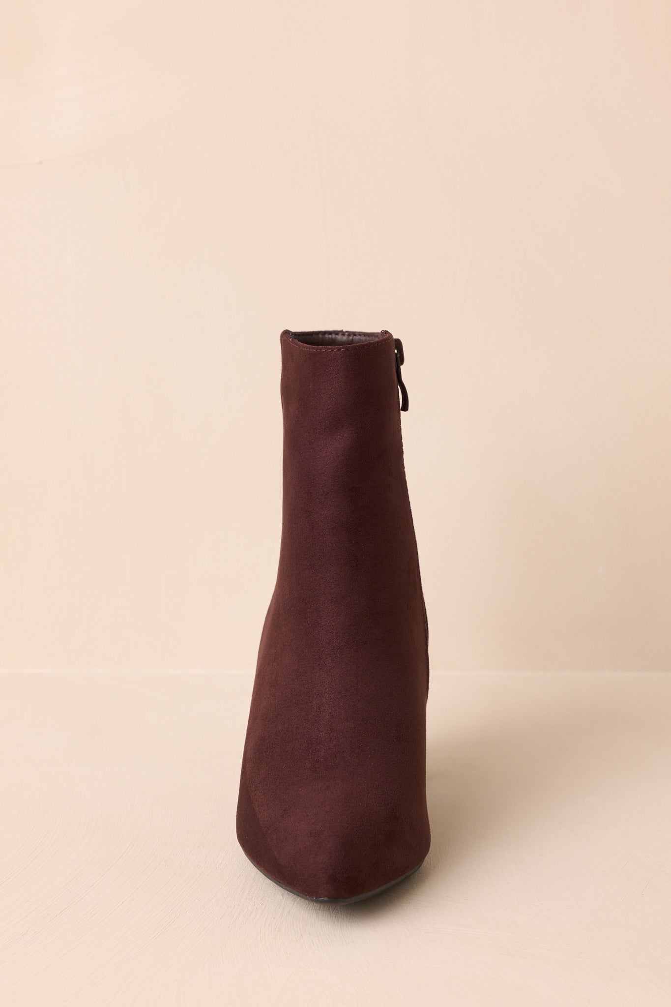 Front angle of the dark brown ankle boots showcasing the pointed toe and structured block heel.