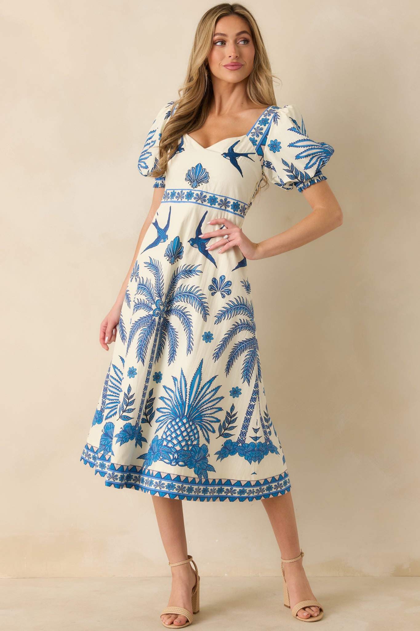 Front-facing angle of the tropical midi dress highlighting the short puff sleeves and fitted bodice.
