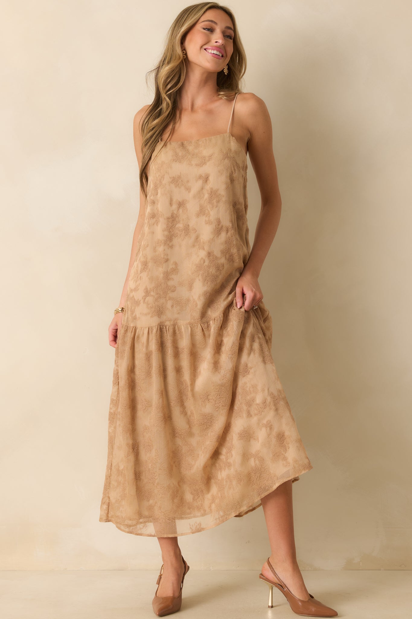 A front angle highlighting the relaxed bodice and drop waist silhouette with softly gathered tiered skirt.