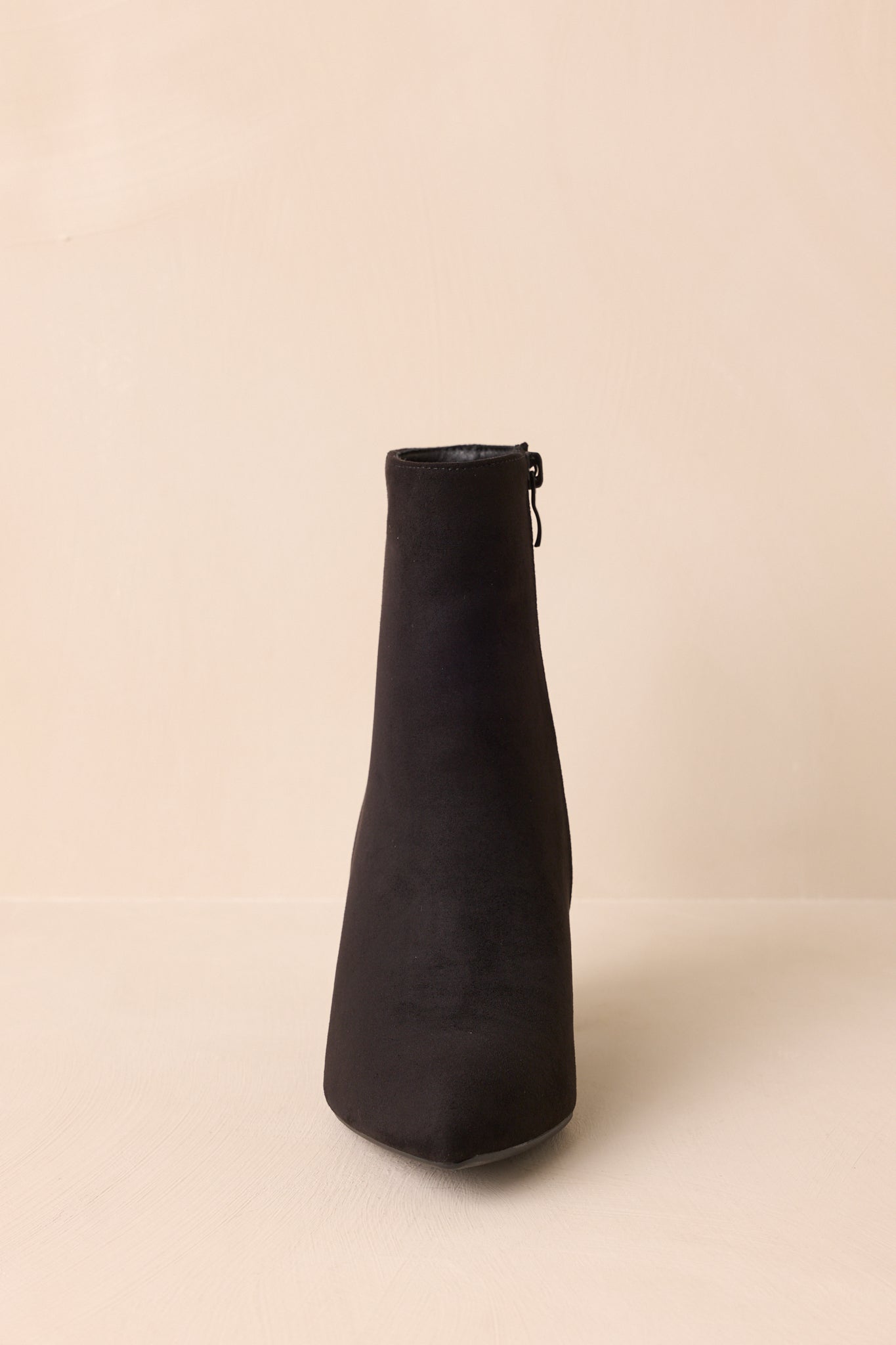 Front angle of the black ankle boots showcasing the pointed toe and block heel.