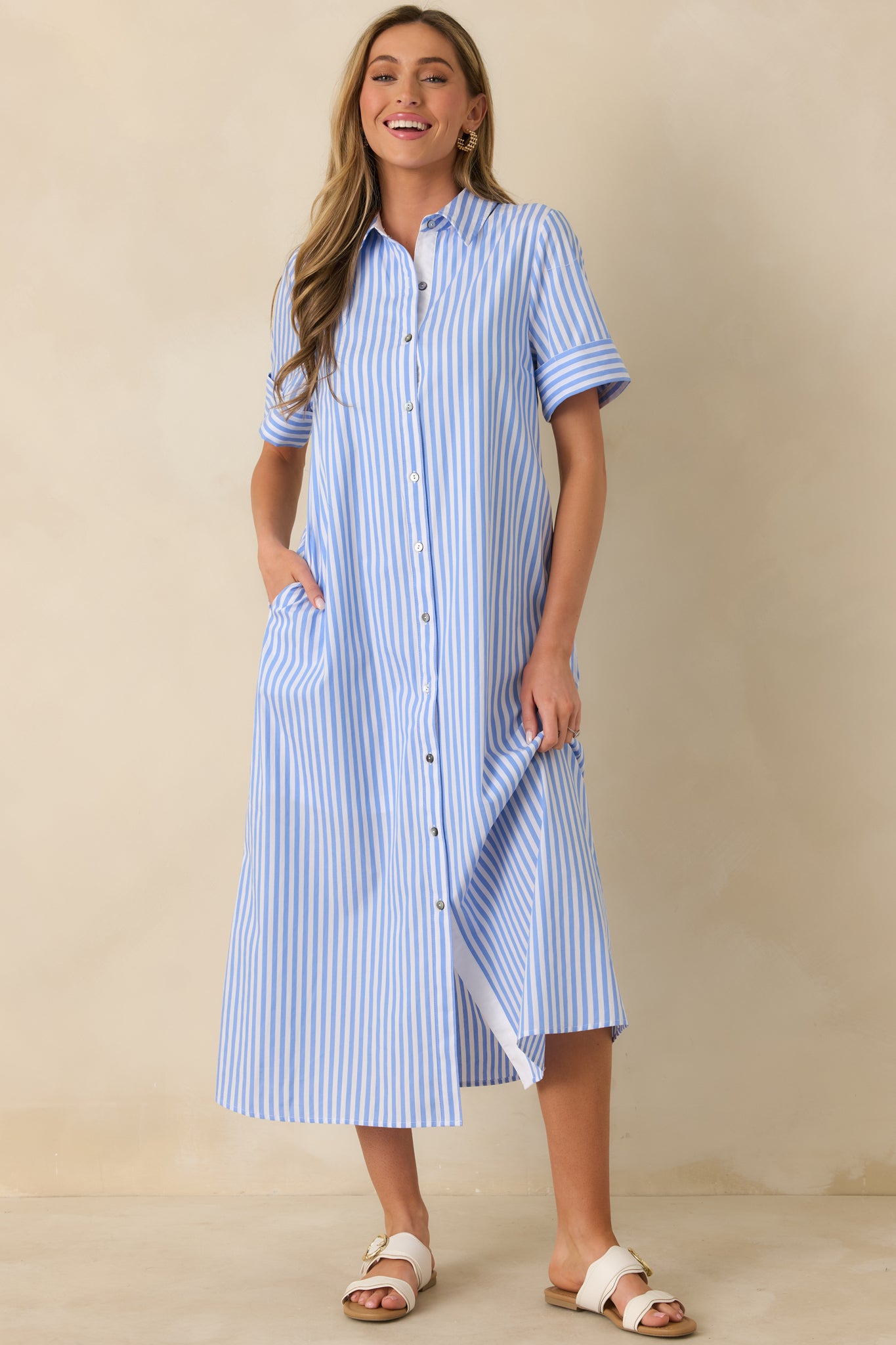 Straight-on front angle showing the crisp collar, short sleeves, and vertical stripe pattern along the bodice.