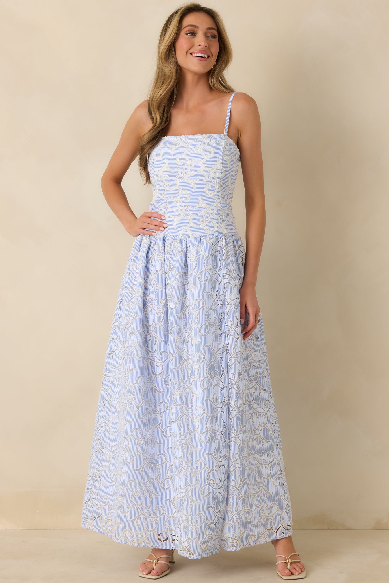 Front view of blue striped maxi dress highlighting the square neckline and fitted bodice.