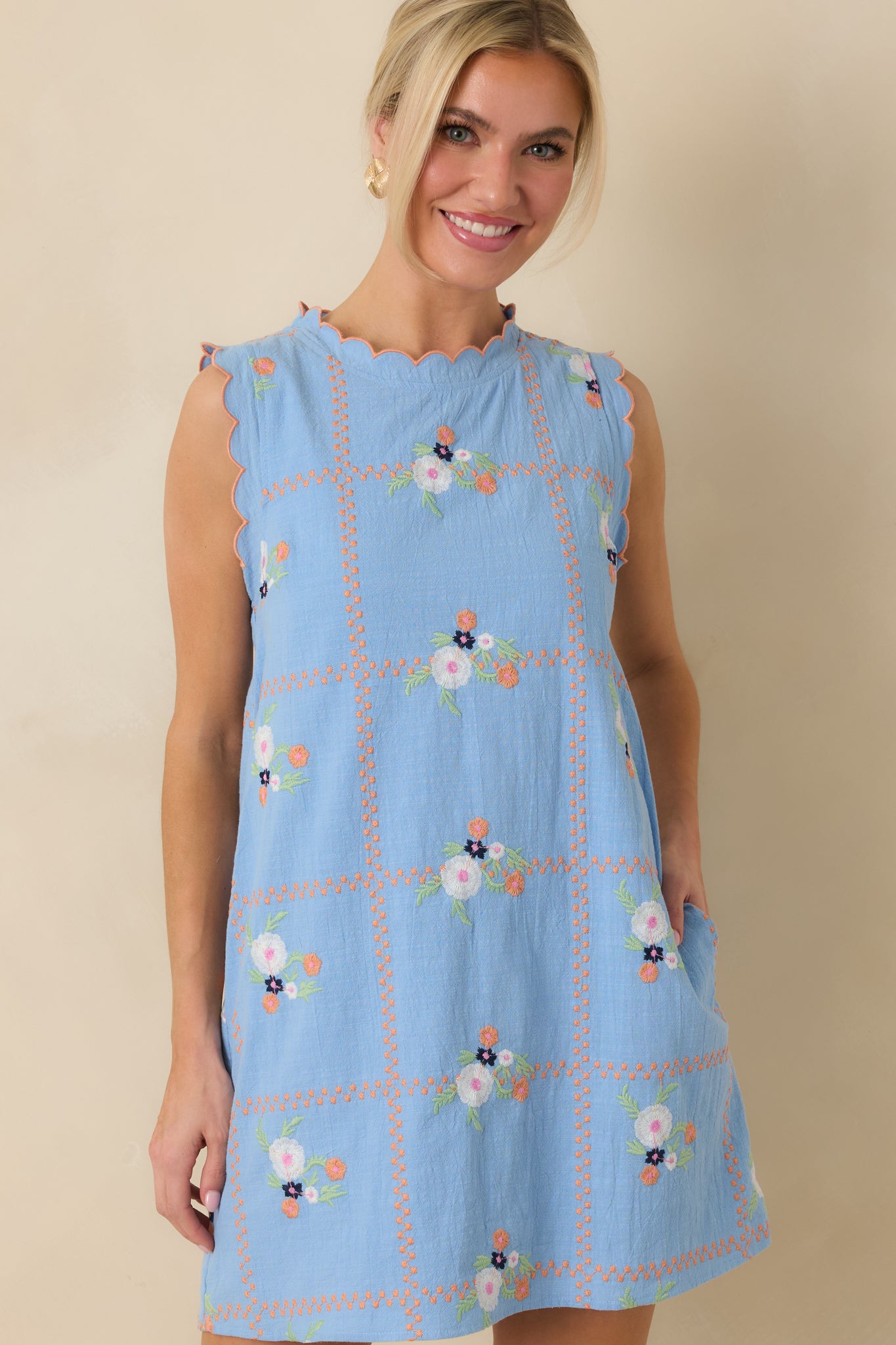 Front-facing crop emphasizing the embroidery pattern and smooth fabric texture along the chest and waist.