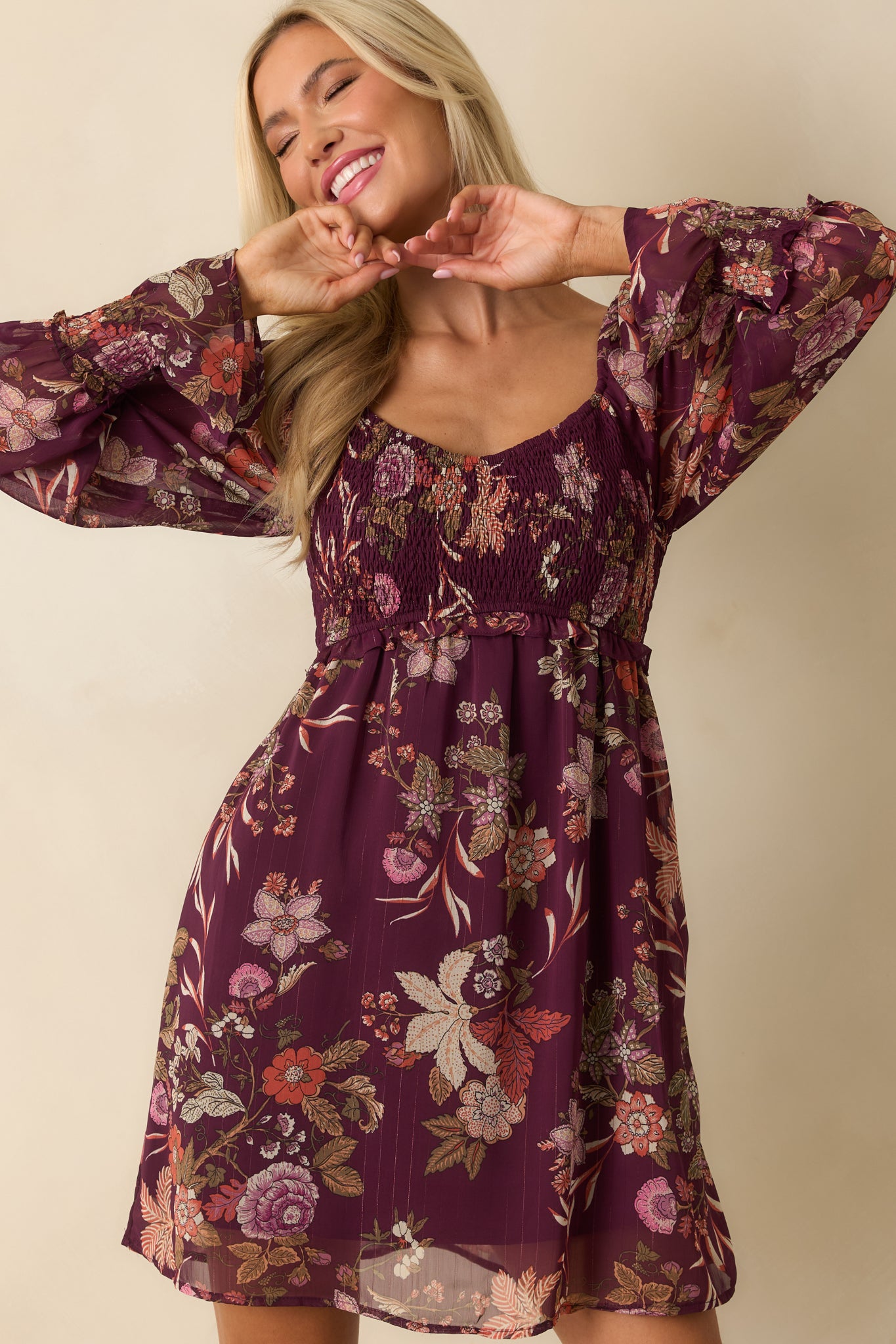 Front crop showing sheer long sleeves with elastic cuffs and floral print fabric.